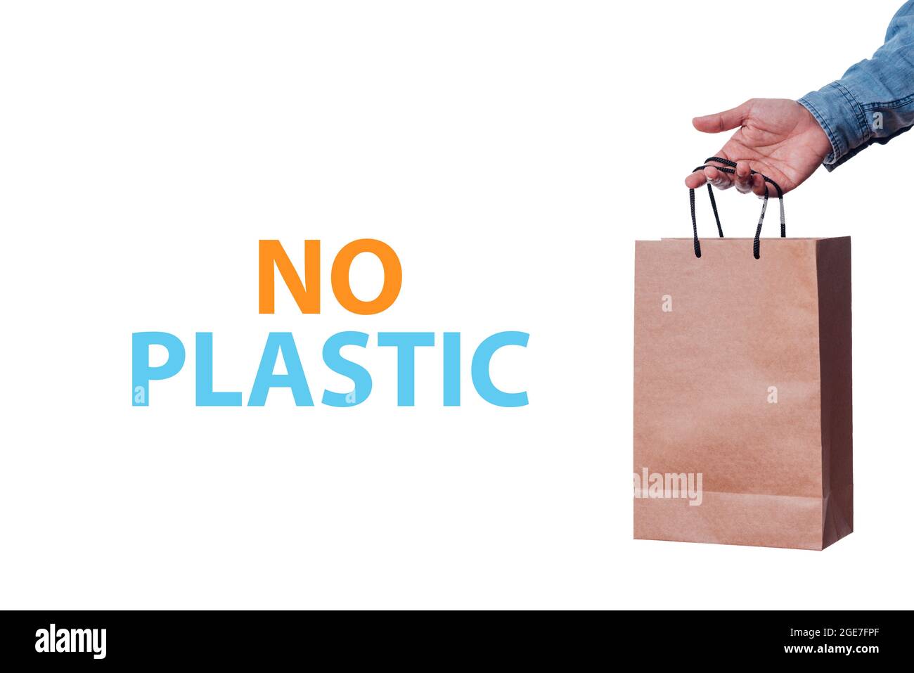 Stock image of a text that says no plastic and a man's hand holding an appel shopping bag on white background Stock Photo