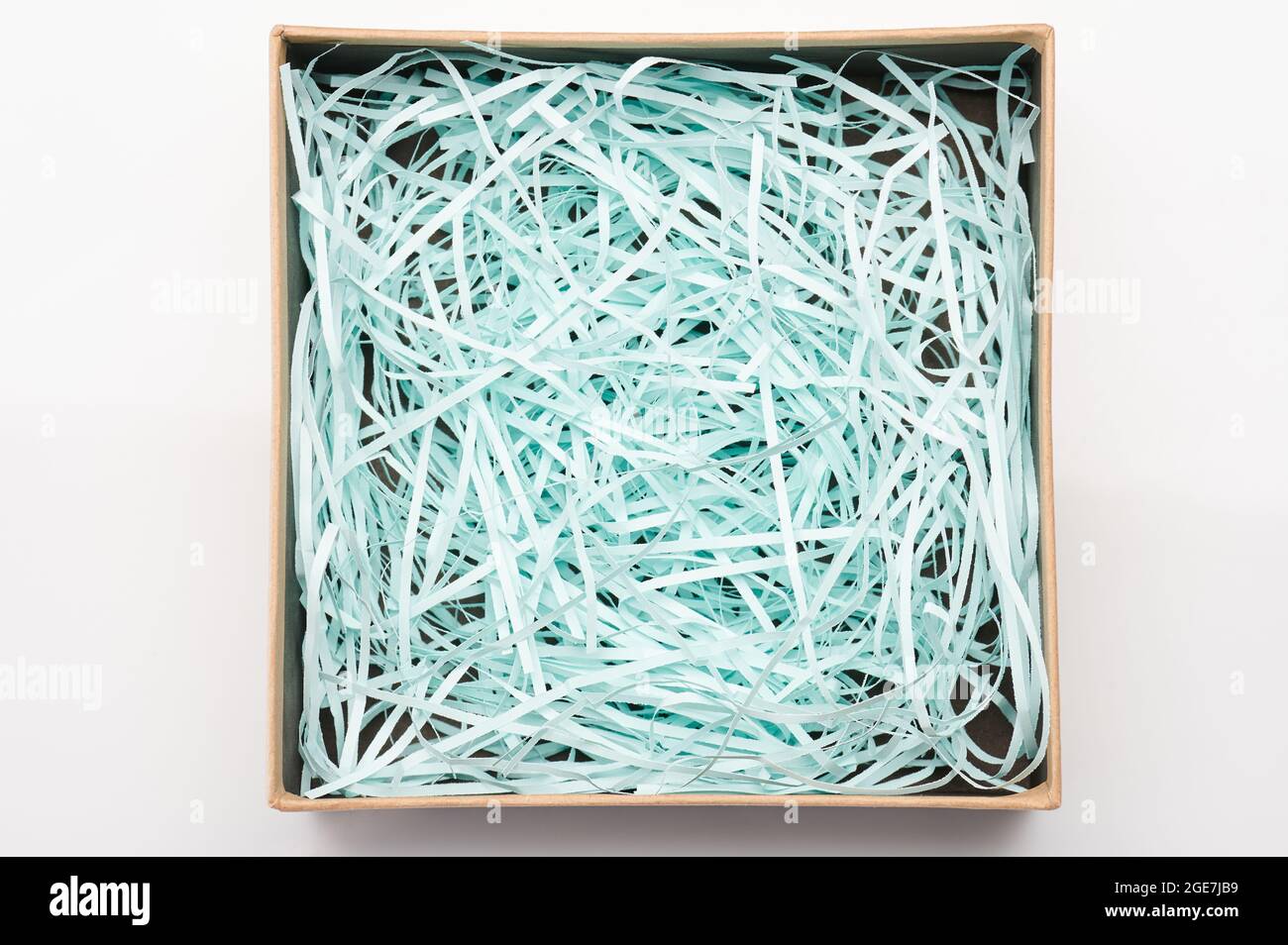 Paper box with shredded soft fiber above top view isolated Stock Photo