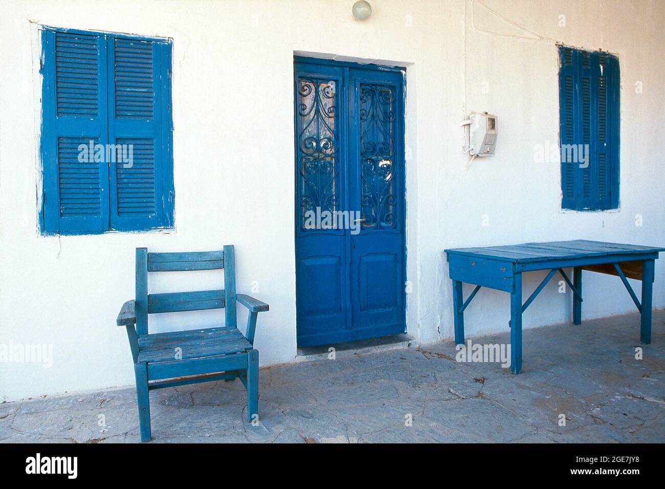 Blue painted table, chair and door, Pefkos, Rhodes, Dodecanese islands, Greece Stock Photo