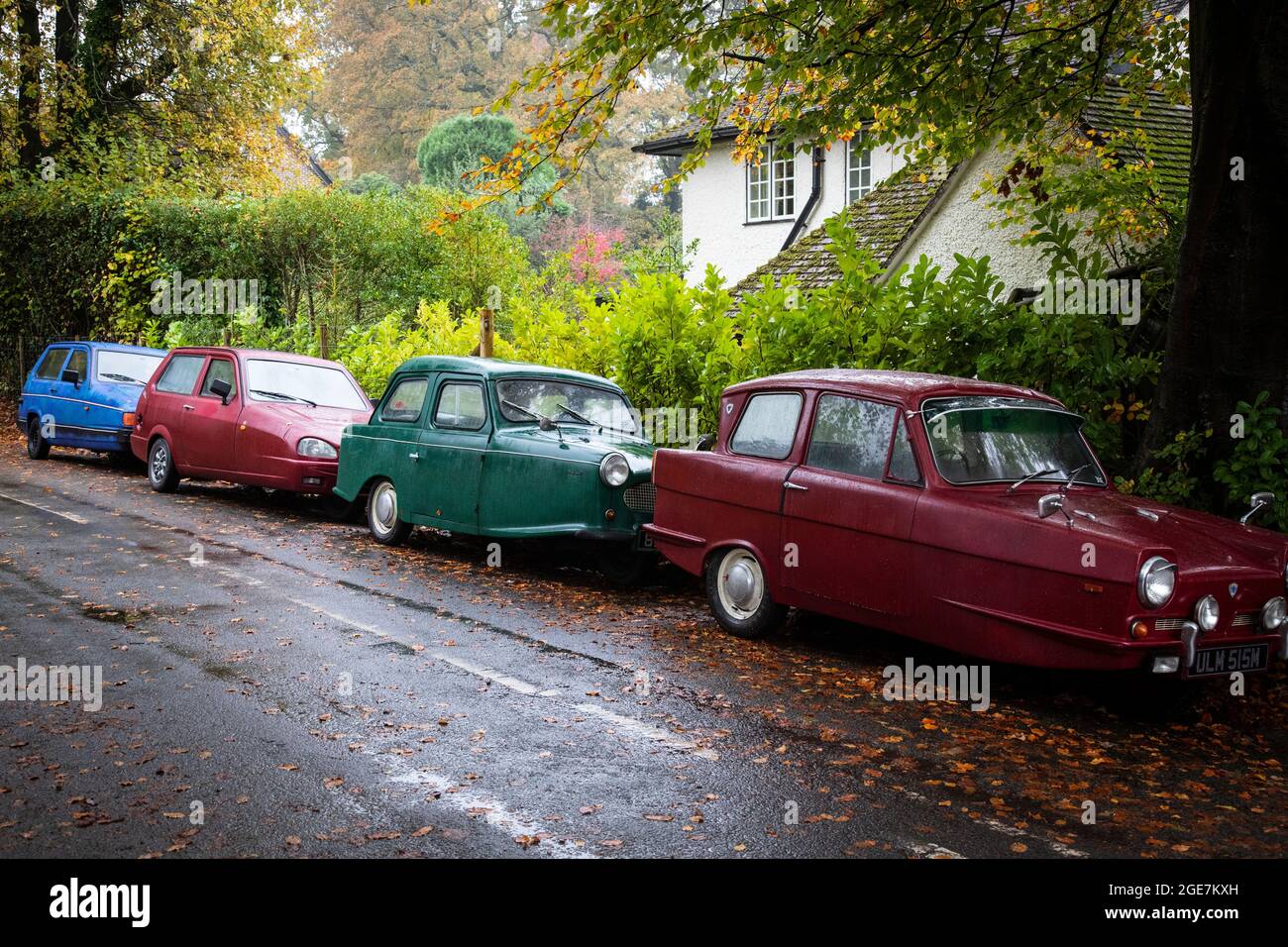 Four Reliant Robins parked in a country road, Surrey, England. Stock Photo