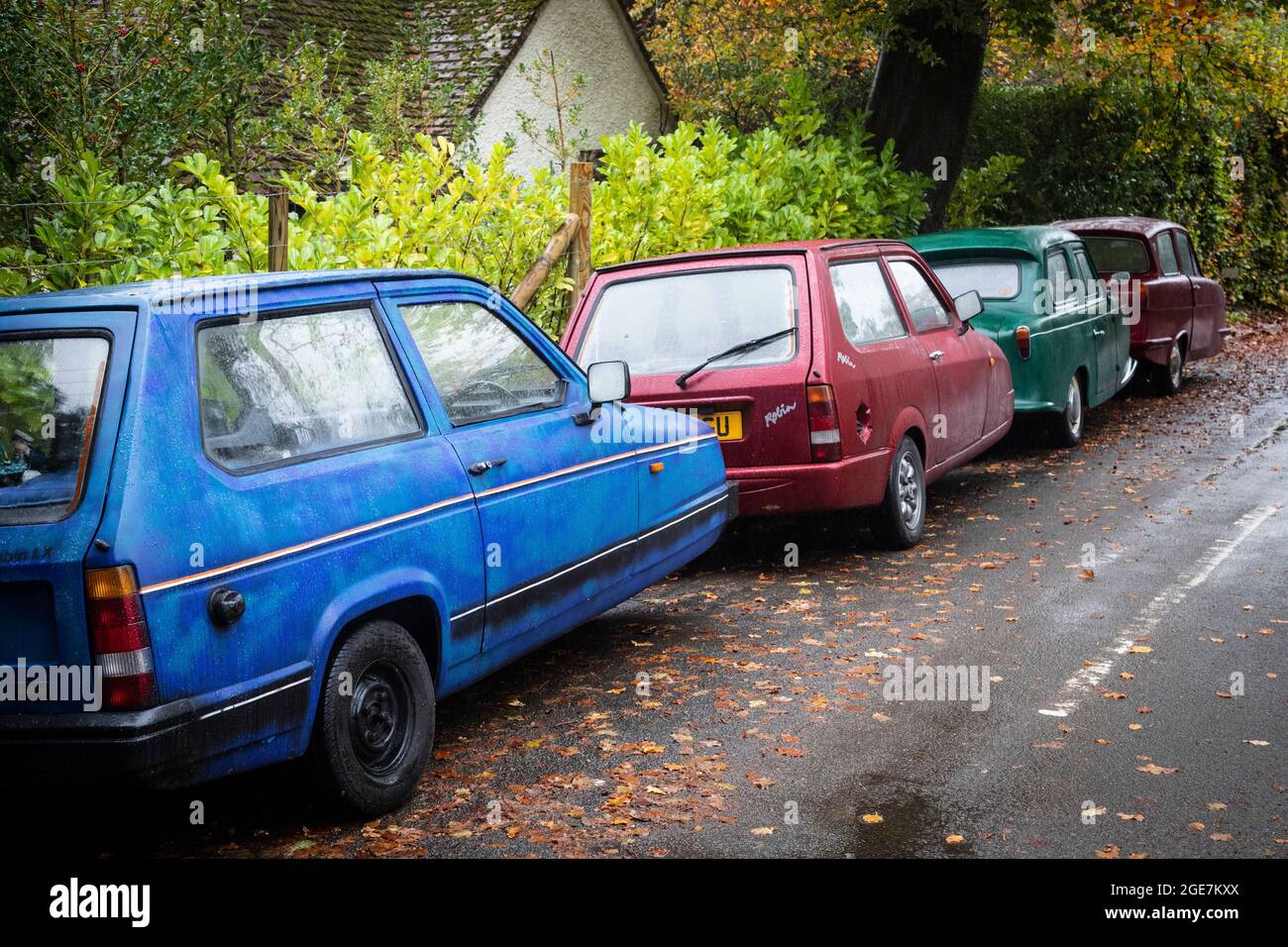 Four Reliant Robins parked in a country road, Surrey, England. Stock Photo