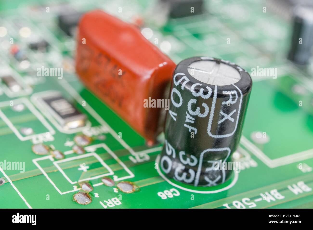 Close-up shot of aluminium electrolytic capacitor on pcb, showing component  rating marking and vent, with dipped film capacitor. Brands unidentified  Stock Photo - Alamy