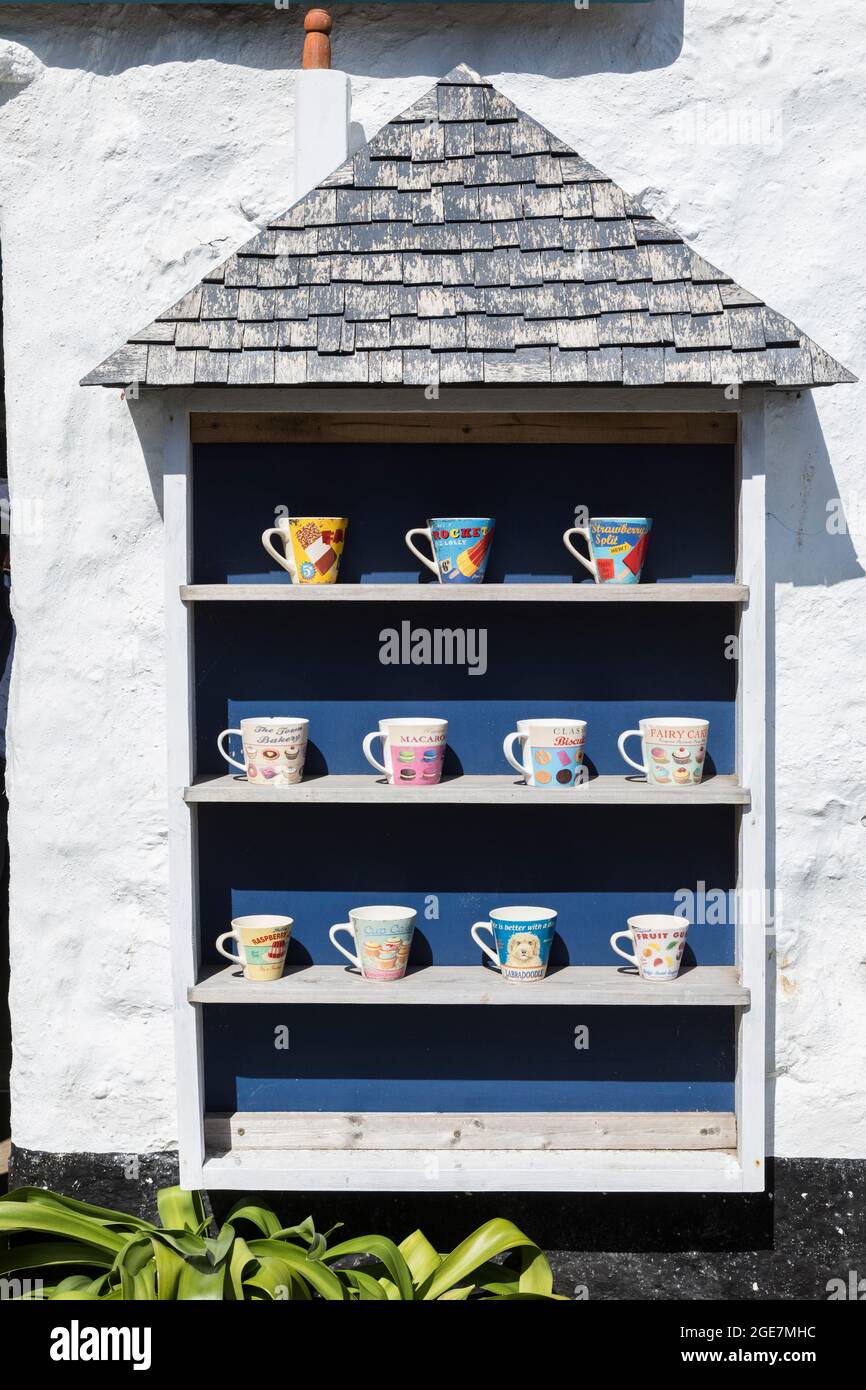 Selection of fun inspired mugs on an outside display in Mousehole, Cornwall, England. Stock Photo