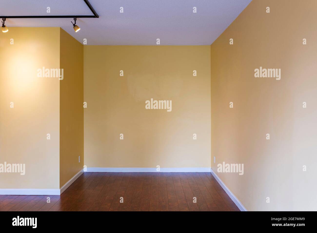 View of empty living room in a modern new apartment condo house interior with empty yellow walls. Stock Photo
