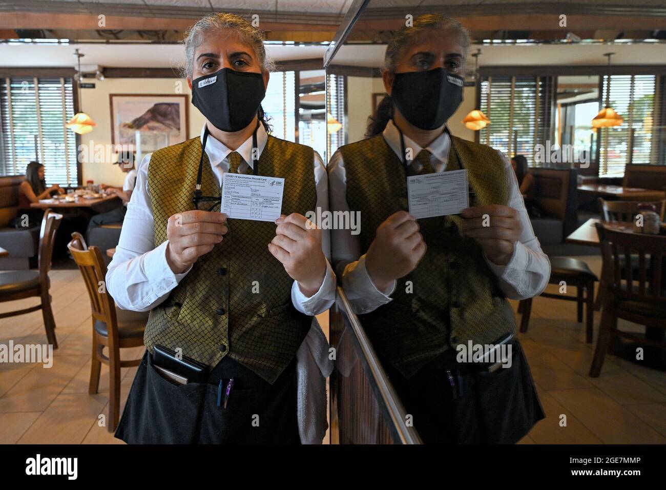 Fouzia Chenafi, a waitress at Peach Diner, poses for a picture