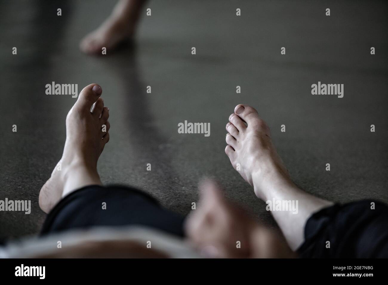 dancers foots, legs, on floor on blurred background Stock Photo