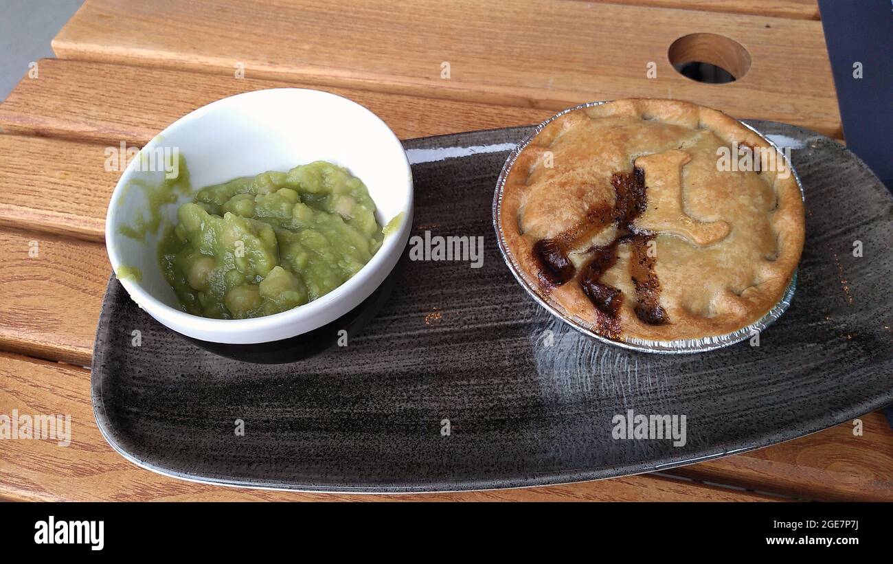 HALIFAX. WEST YORKSHIRE. ENGLAND. 05-29-21. The Piece Hall courtyard, minced lamb pie and mushy peas at the Bakery Cafe. Stock Photo