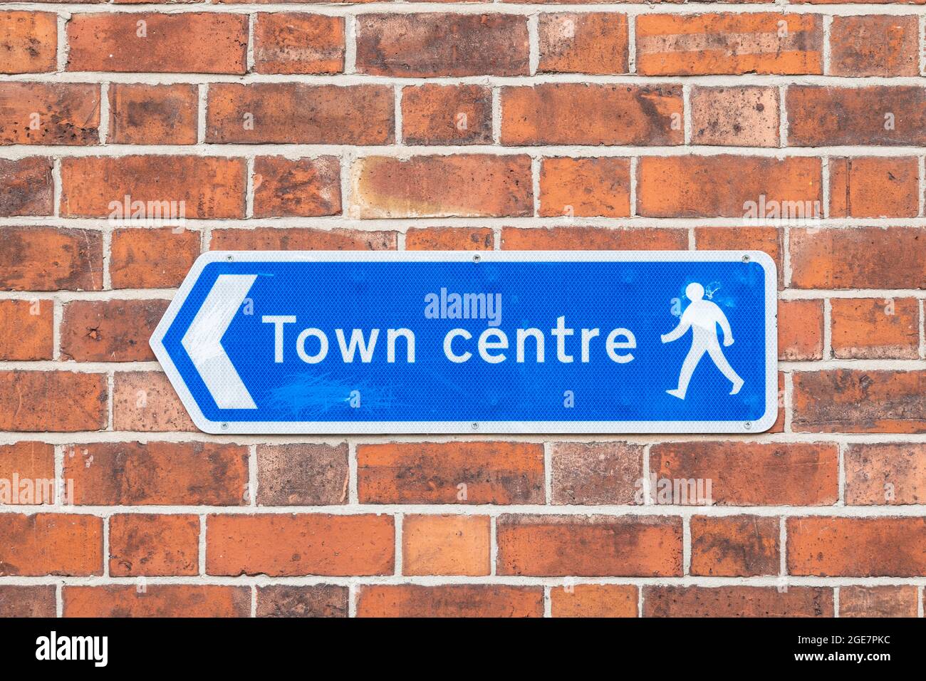 Blue sign on a brick wall directing pedestrians to the 'Town Centre'. Stock Photo