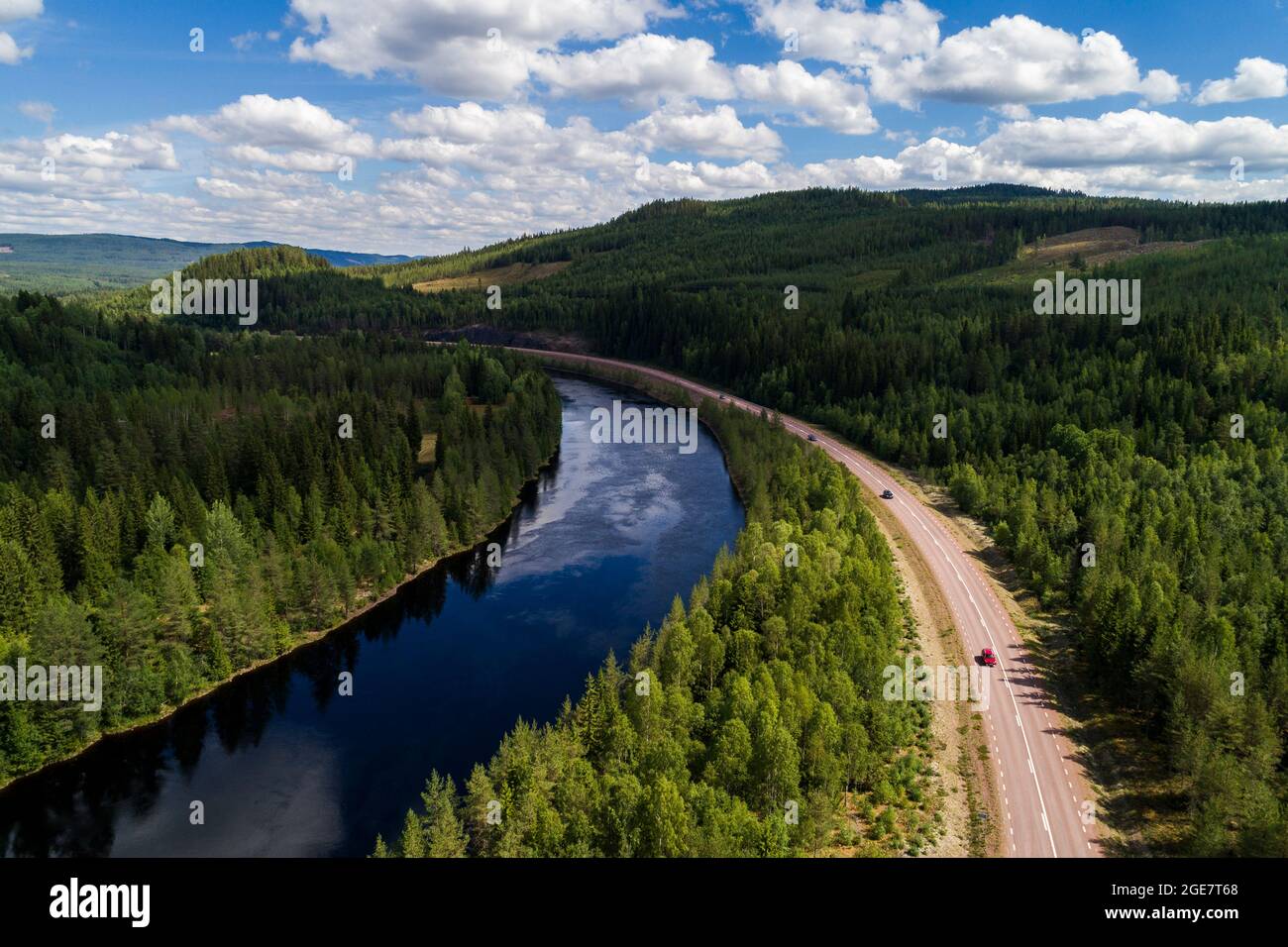 High angle aerial view of river and road running through forest and mountainous landscape in northern Sweden Stock Photo