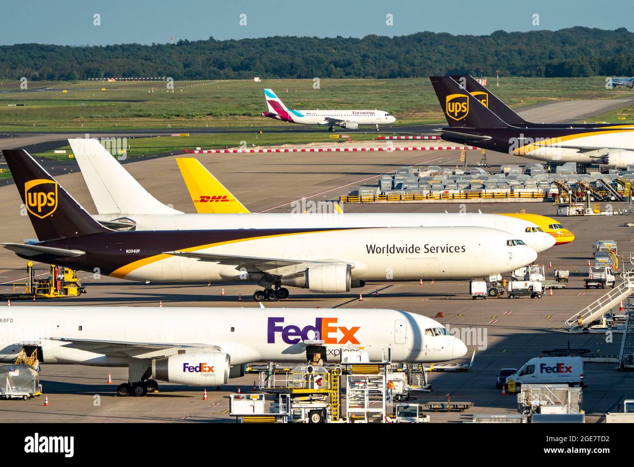 Cologne-Bonn Airport, CGN, cargo aircraft standing in front of the air cargo centre, being loaded and unloaded, Eurowings Airbus taxiing for take-off, Stock Photo