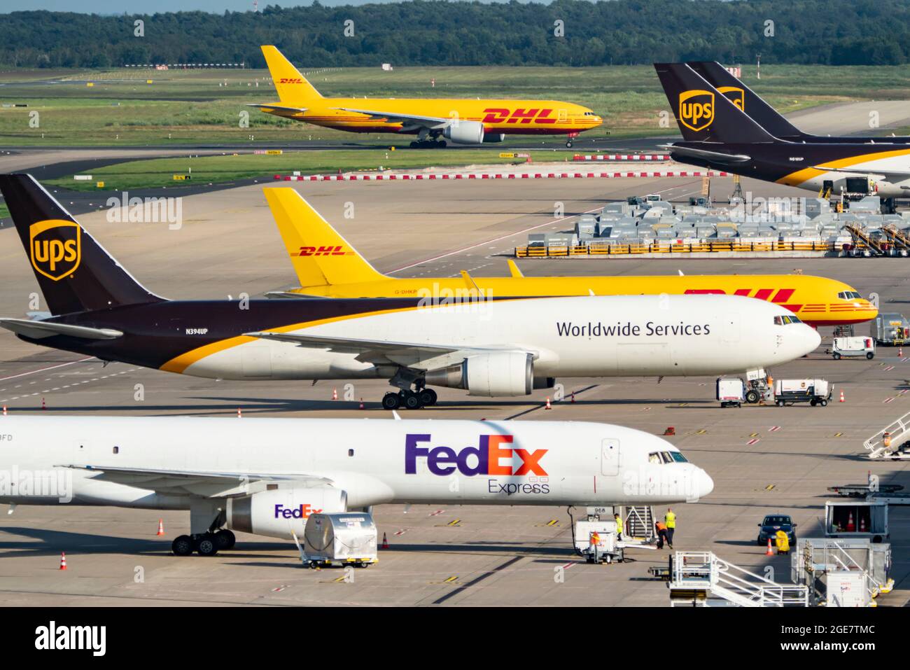 Cologne-Bonn Airport, CGN, cargo aircraft standing in front of the air cargo centre, being loaded and unloaded, DHL Boeing 777 taxiing for take-off, N Stock Photo