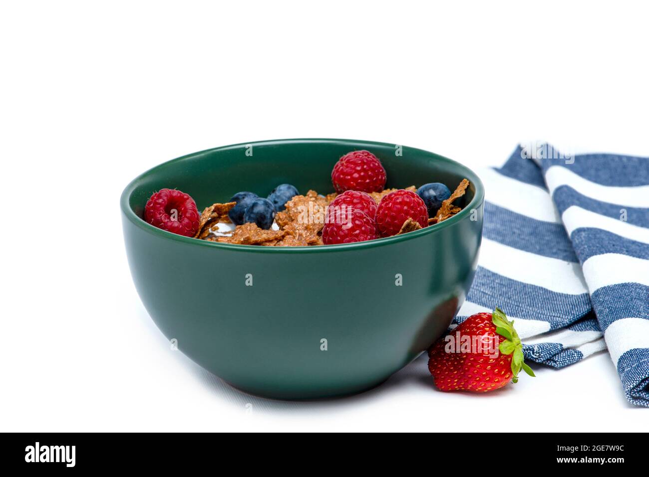 Muesli, isolate on white. Breakfast, healthy food and diet. Muesli with fruits and milk in a plate. Blueberries, strawberries and raspberries on a Stock Photo