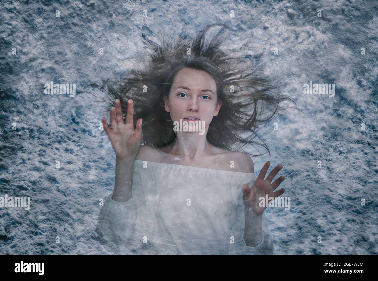 girl lies in the snow frozen under the ice in Halloween. The image of