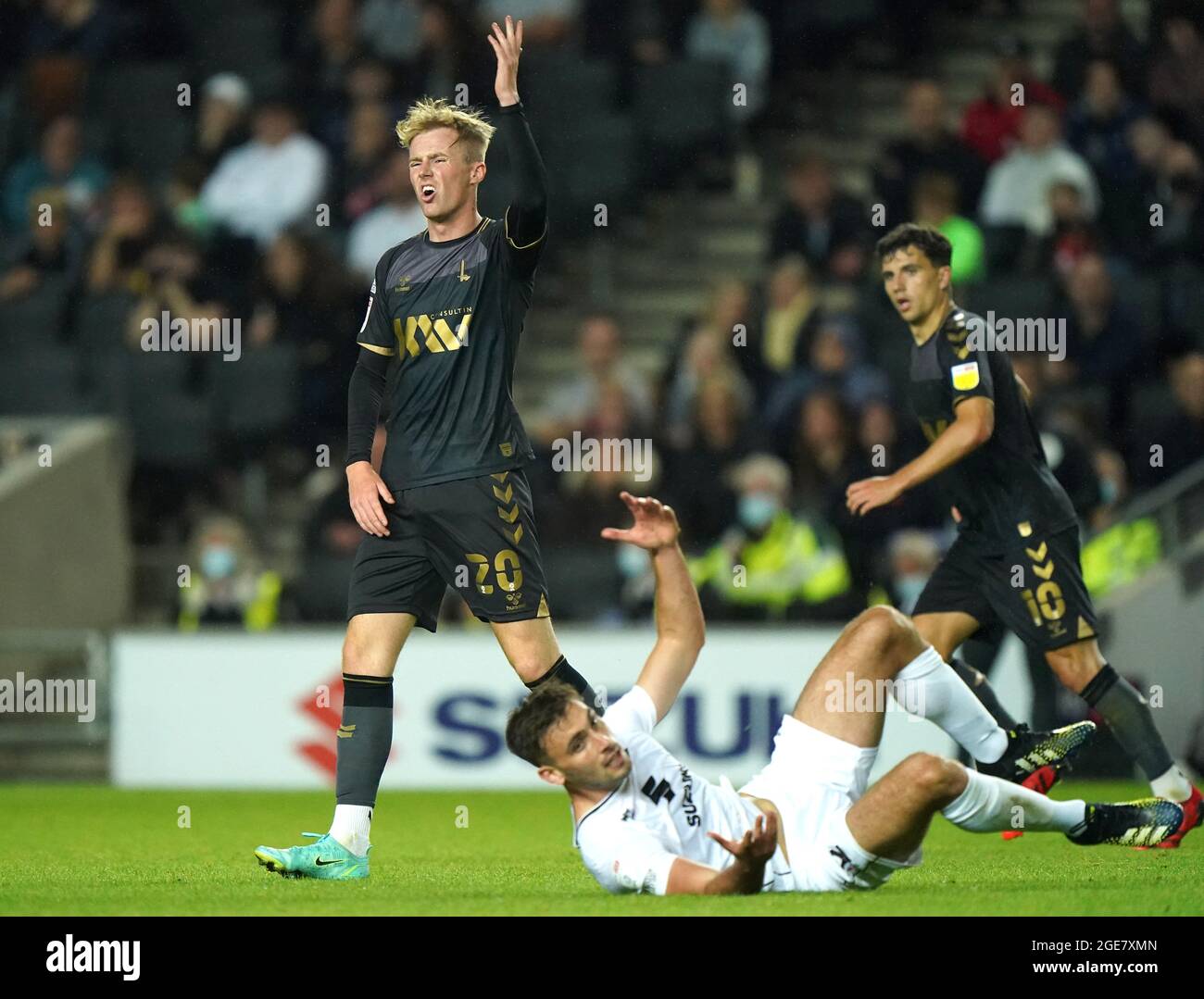 Charlton Athletic's Charlie Kirk (left) reacts after Milton Keynes Dons' Warren O'Hora falls to the floor during the Sky Bet League One match at Stadium MK, Milton Keynes. Picture date: Tuesday August 17, 2021. Stock Photo