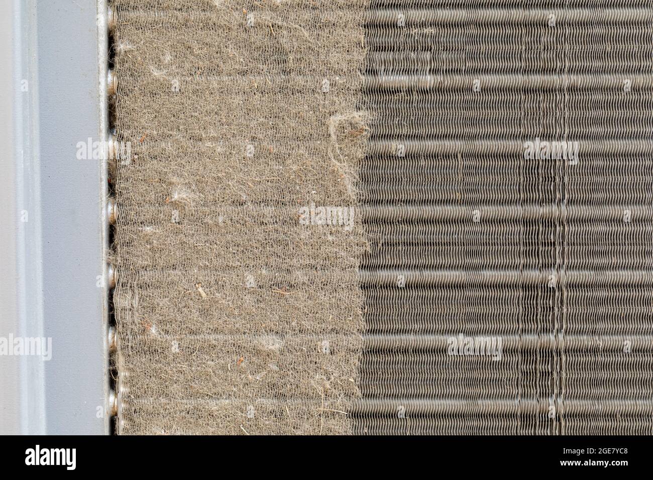 Dirty air conditioning unit. Condenser coil full of dirt and grass debris. Concept of home air conditioning, hvac, repair, service, cleaning and maint Stock Photo