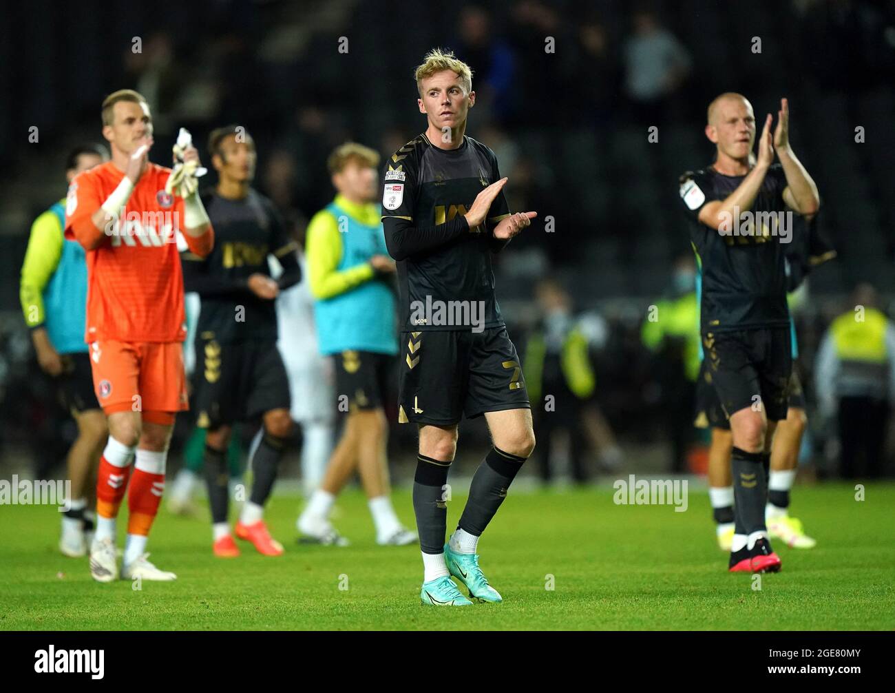 Charlton Athletic's Charlie Kirk (centre), goalkeeper Craig MacGillivray (left) and Ben Watson applaud the fans after the final whistle during the Sky Bet League One match at Stadium MK, Milton Keynes. Picture date: Tuesday August 17, 2021. Stock Photo