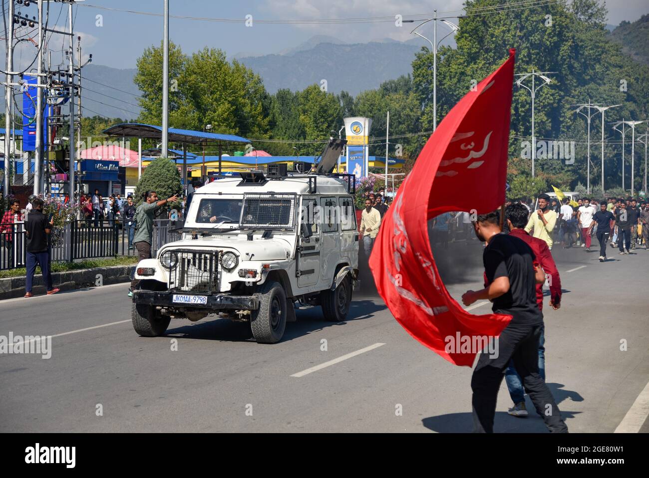 A Kashmiri Shia Muslim man waves religious flag as Indian armored ...