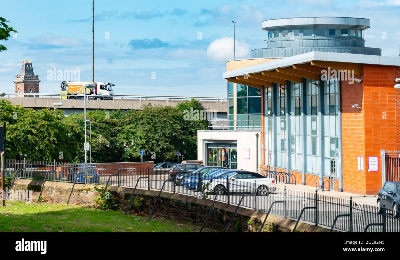 Alsop Lifestyles Leisure centre including swimming pool, in Walton Village, with the old Walton Hospital Tower behind Queens Drive Flyover. Stock Photo