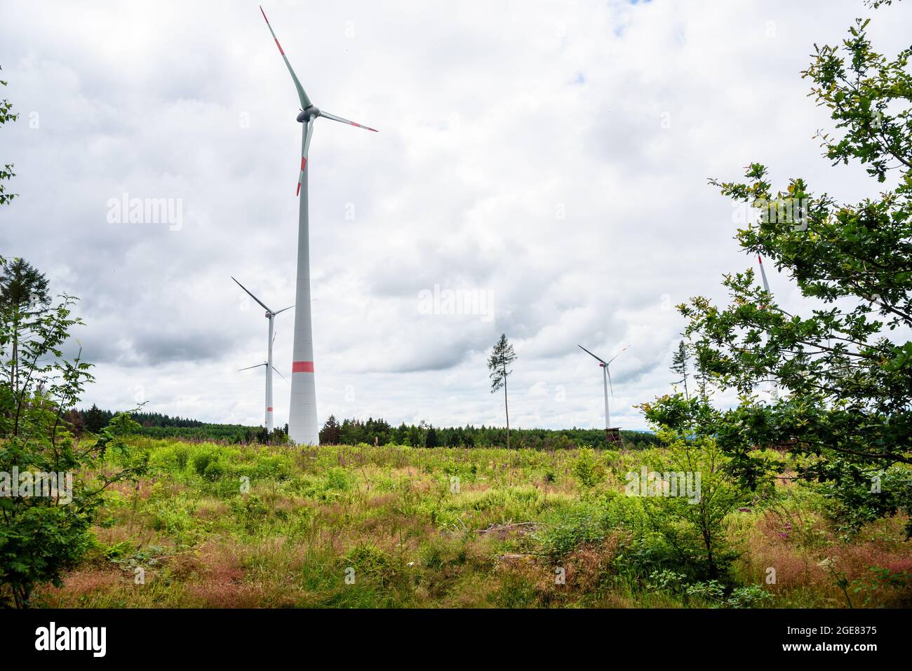 Wind farm in the countryside of Germany under cloudy sky Stock Photo