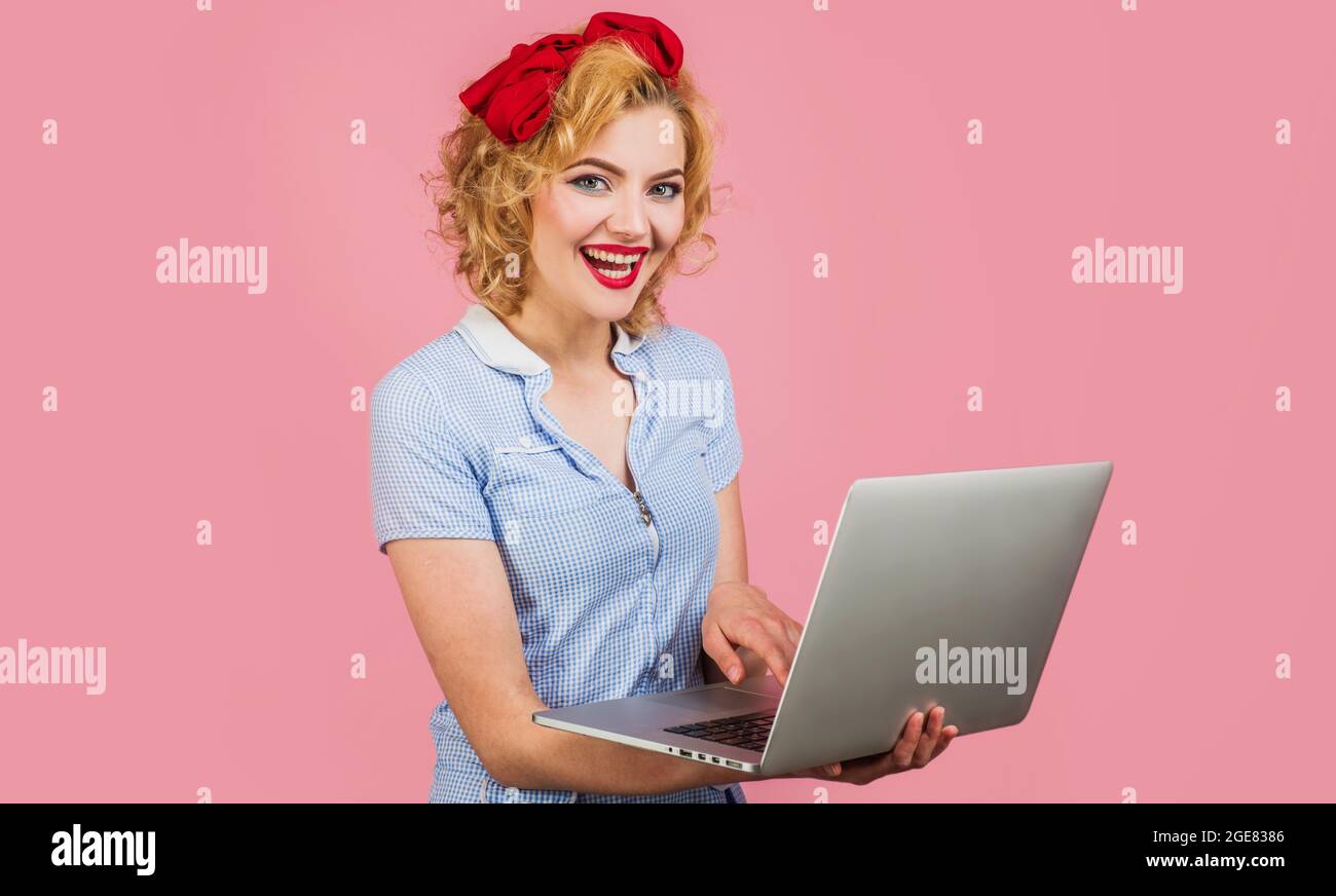 Online sales. Smiling young woman with laptop computer. Searching in internet. Advertising. Stock Photo
