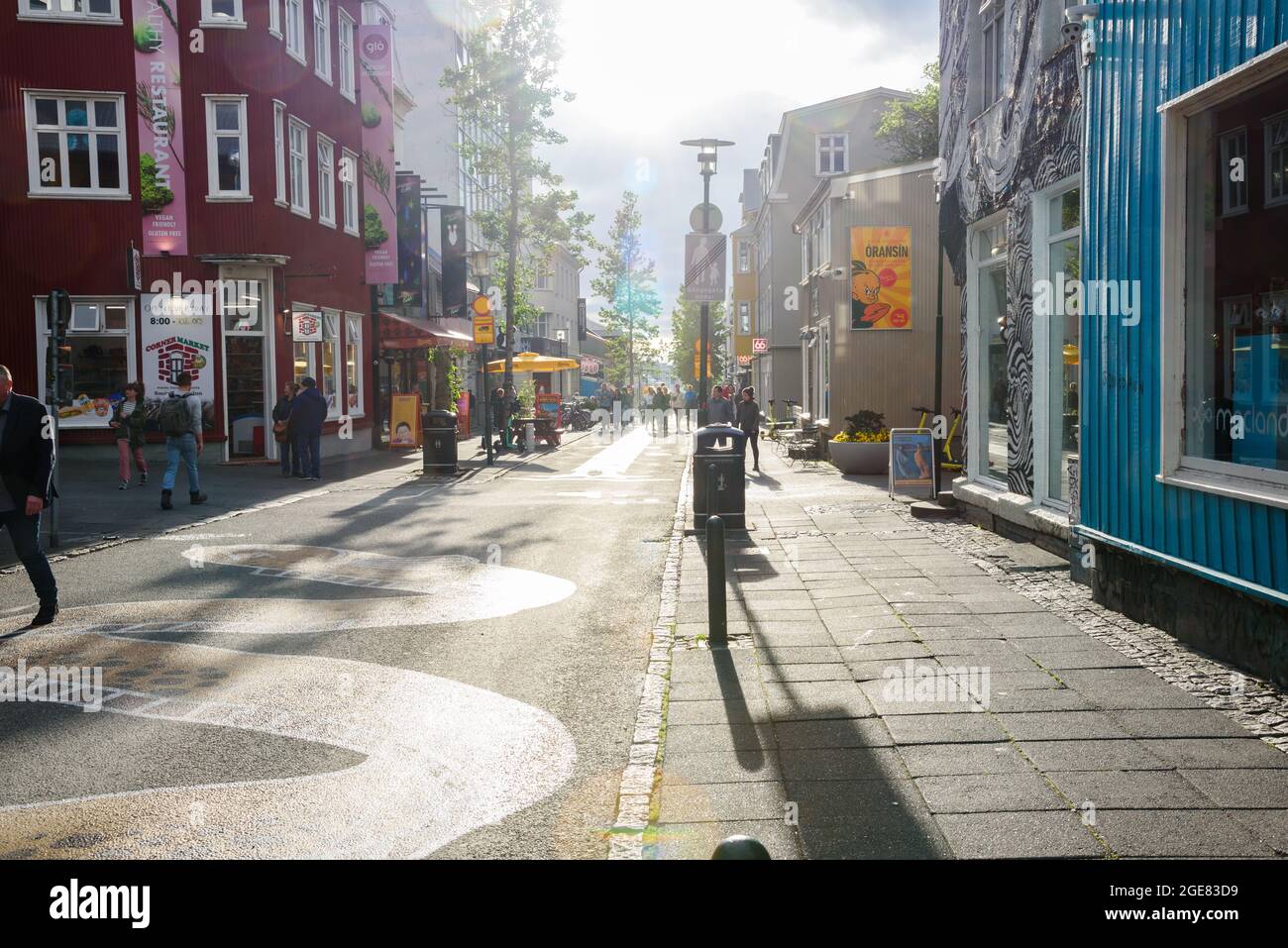 People stolling along Laugavegur, as hopping street in Reykjavik city centre, on a sunny summer evening Stock Photo