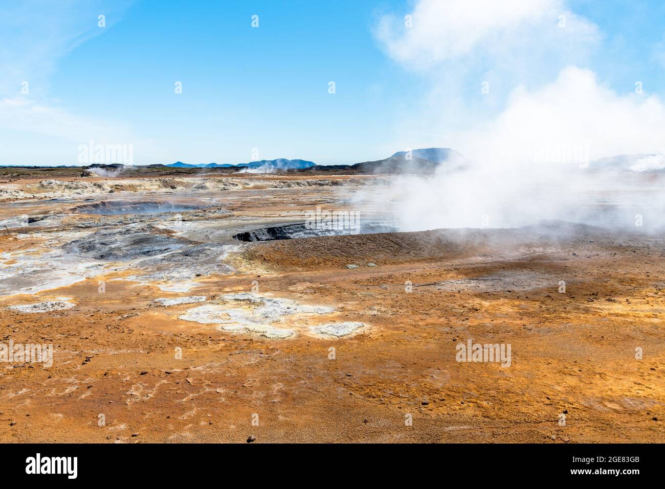 Geothermal area with steaming mud pools on a clear summer day Stock Photo