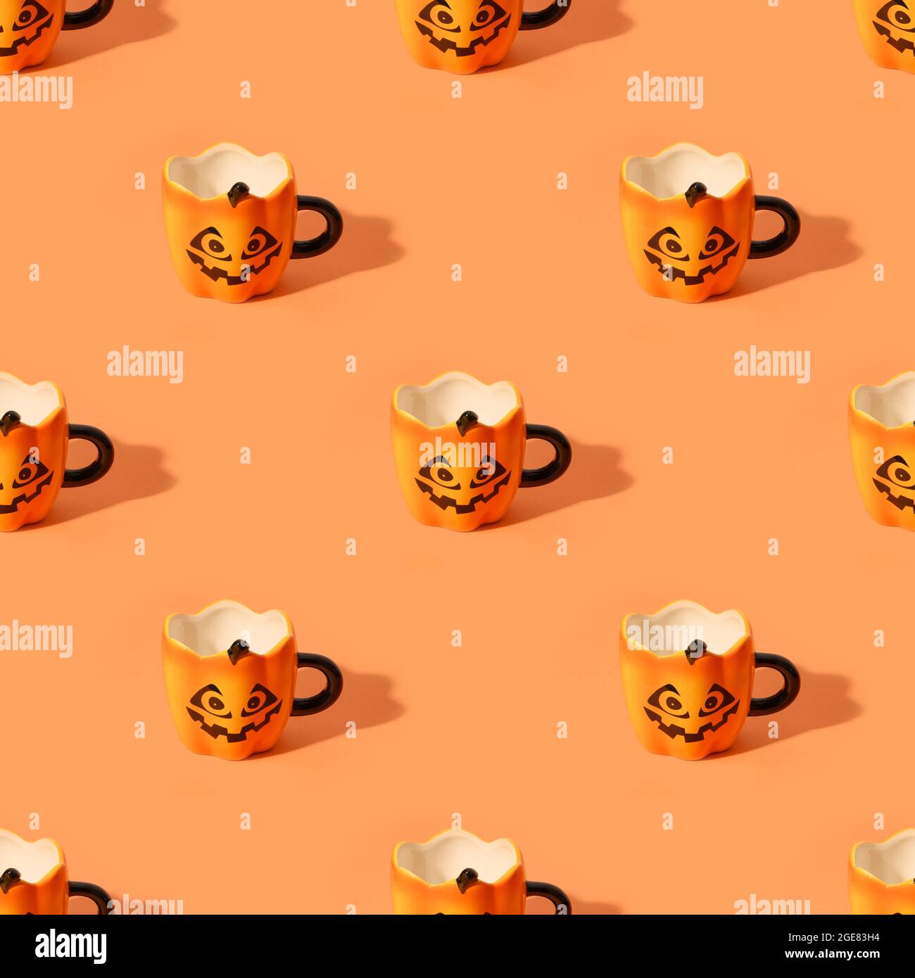Seamless pattern of empty Halloween fun cups on orange background. Stock Photo
