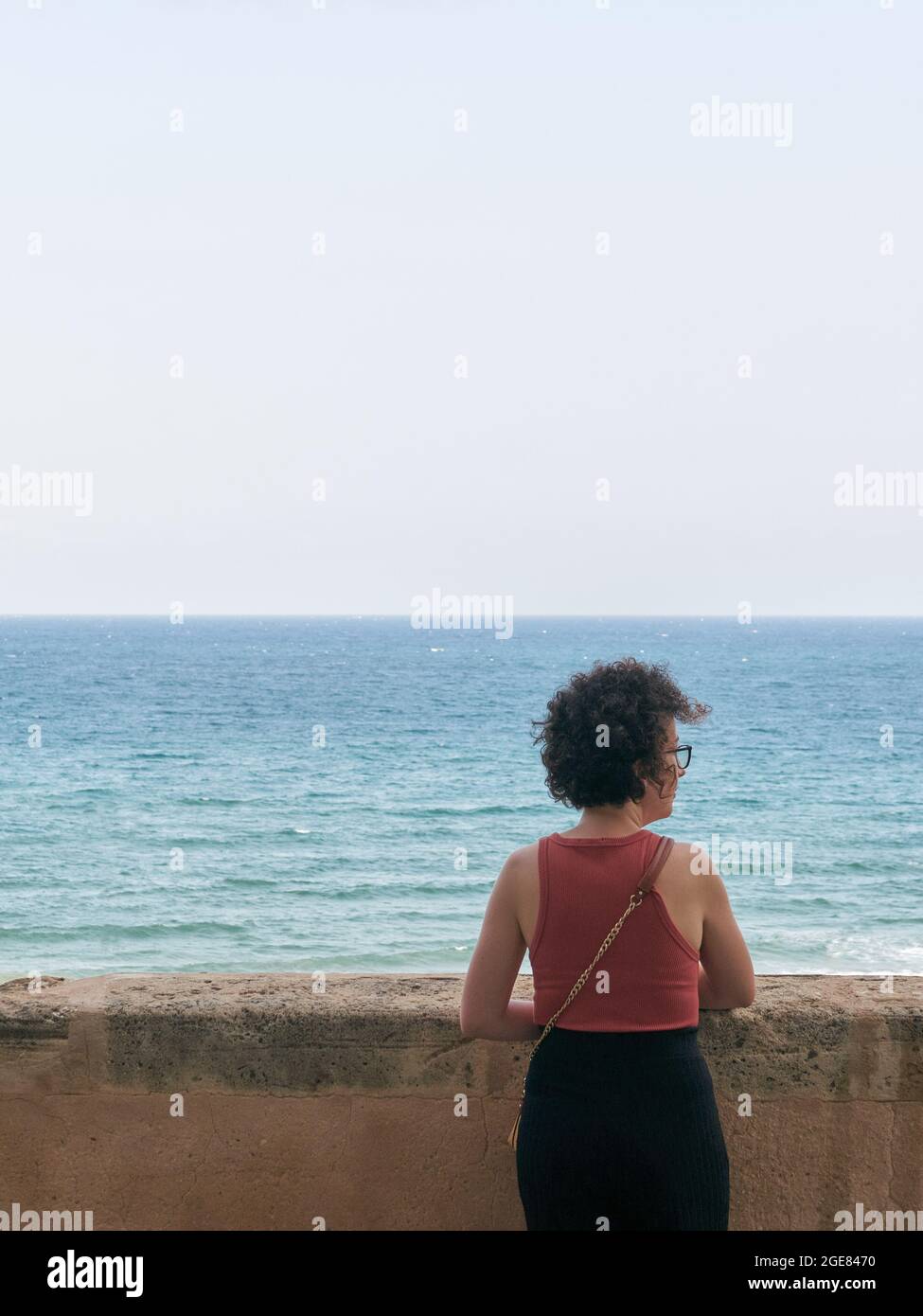 Caucasian woman at a viewpoint in front of the Mediterranean Sea Stock Photo