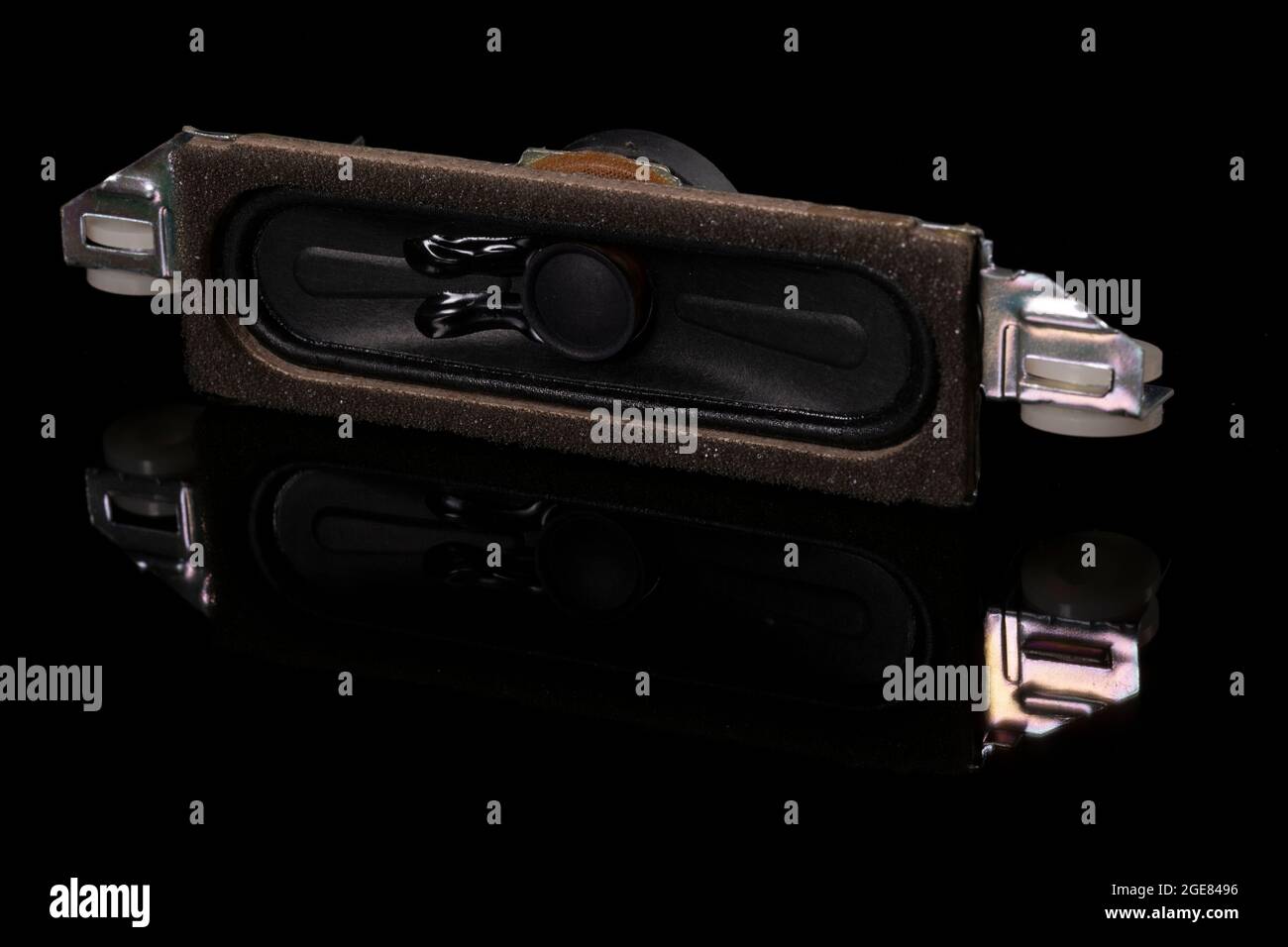 Speaker from a multimedia device on a dark base. Spare parts for TV