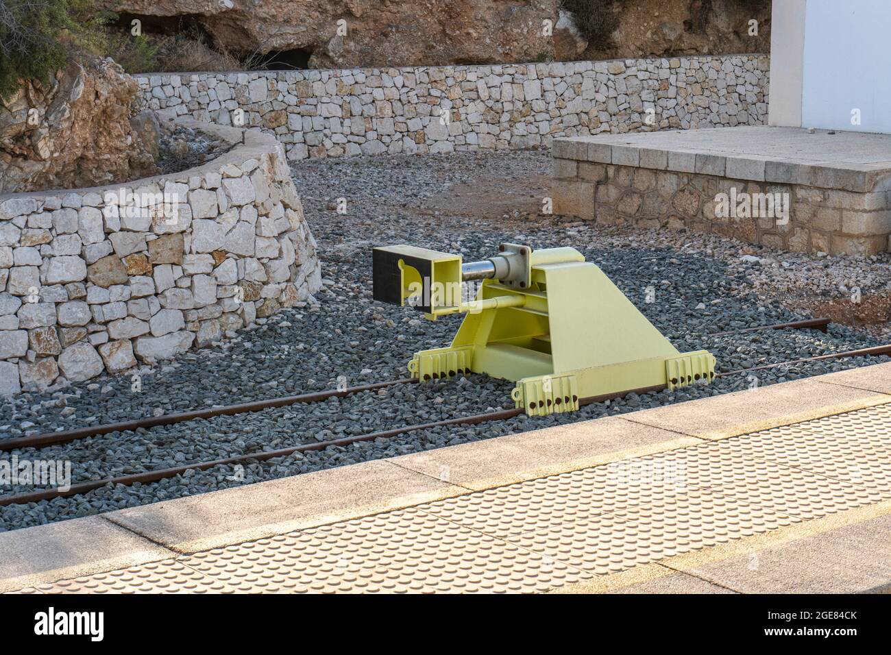 Yellow railway buffer on a train station Stock Photo