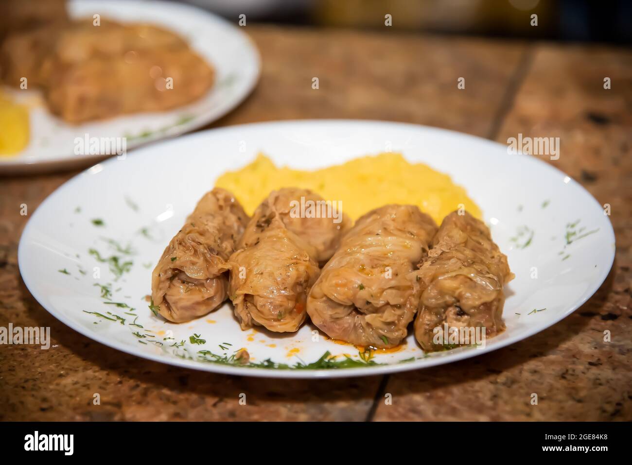 sarmale with polenta on the bar counter, on a plate decorated with parsley Stock Photo