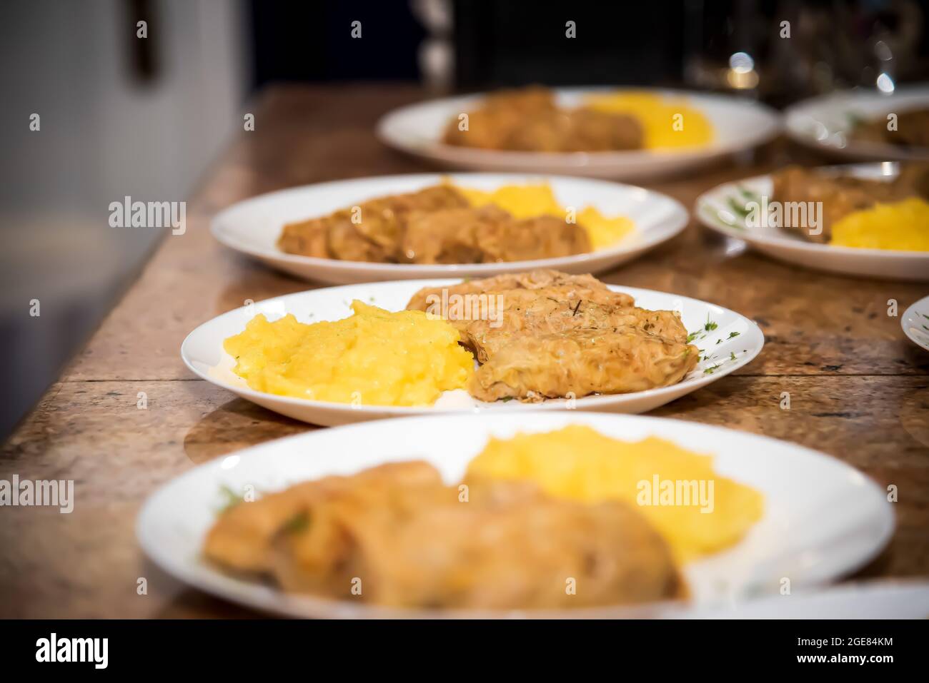 sarmale with polenta on the bar counter, on a plates decorated with parsley Stock Photo