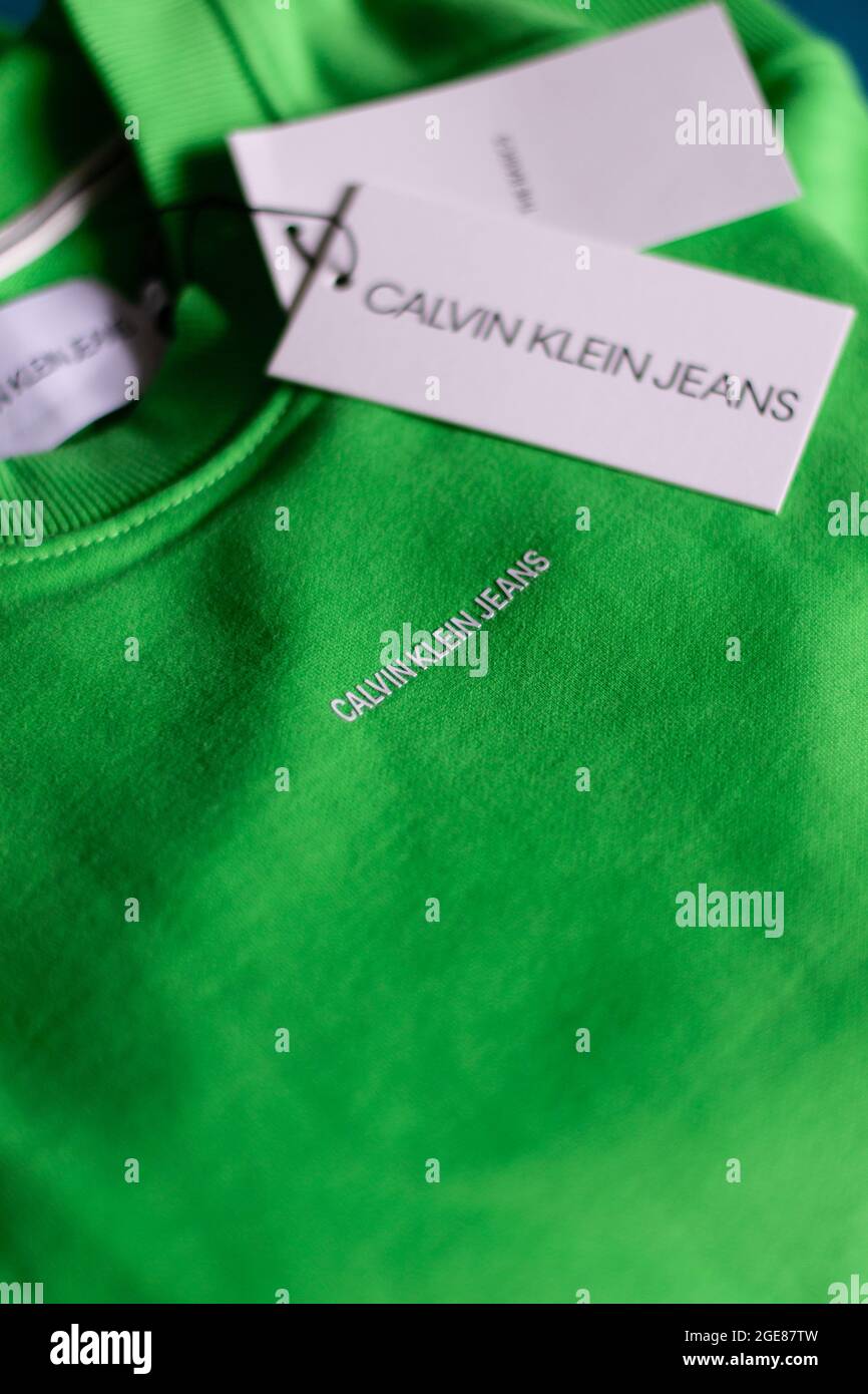 OSIJEK, CROATIA - Jul 26, 2021: A closeup view of the front of a Calvin Klein relaxed organic cotton sweatshirt acid green on black Stock Photo