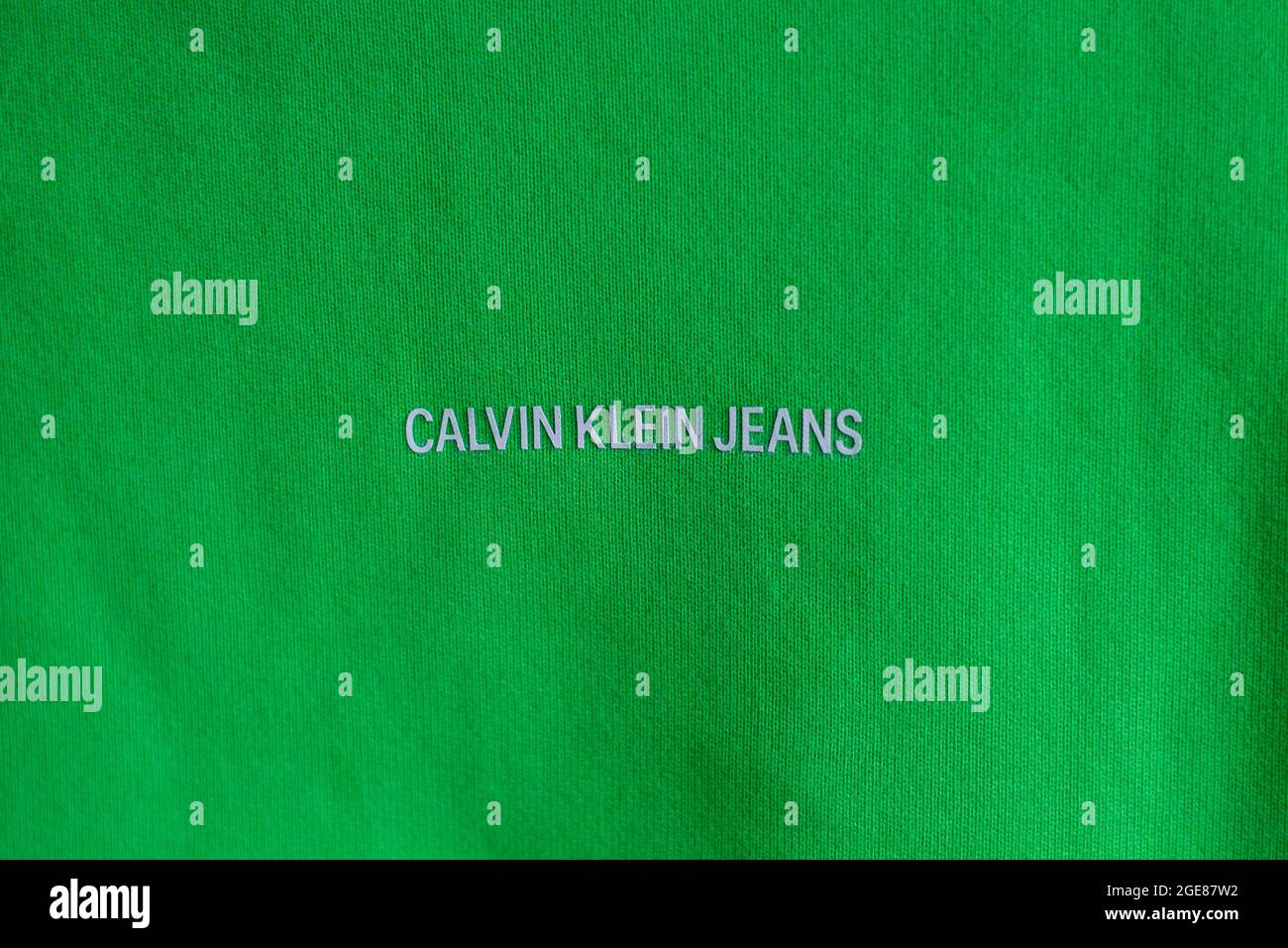 OSIJEK, CROATIA - Jul 26, 2021: A closeup view of the front of a Calvin Klein relaxed organic cotton sweatshirt acid green on black Stock Photo