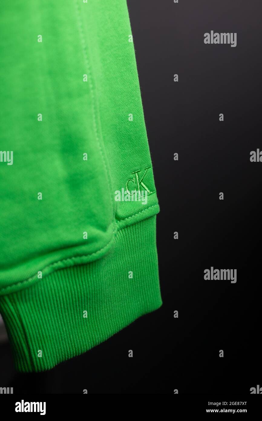 OSIJEK, CROATIA - Jul 26, 2021: A closeup view of the sleeve of a Calvin Klein relaxed organic cotton sweatshirt acid green on black Stock Photo