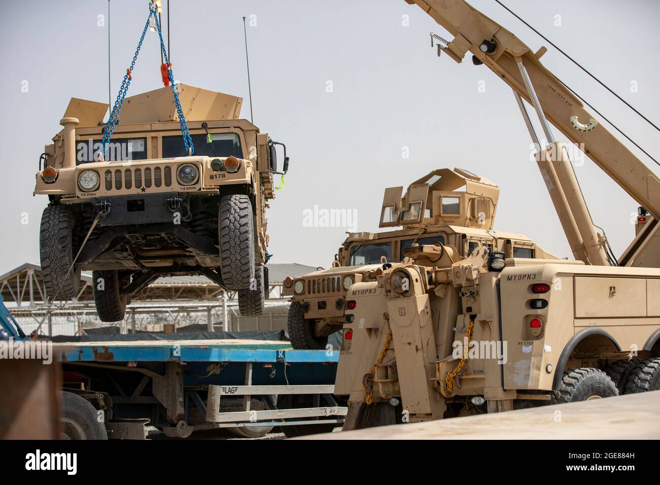 U.S. Soldiers and contractors load High Mobility Multi-purposed Wheeled Vehicles, HUMVs, to be sent for transport in support of the Resolute Support retrograde mission in Afghanistan, July 13, 2020. (U.S. Army photo by Sgt. Jeffery J. Harris) Stock Photo