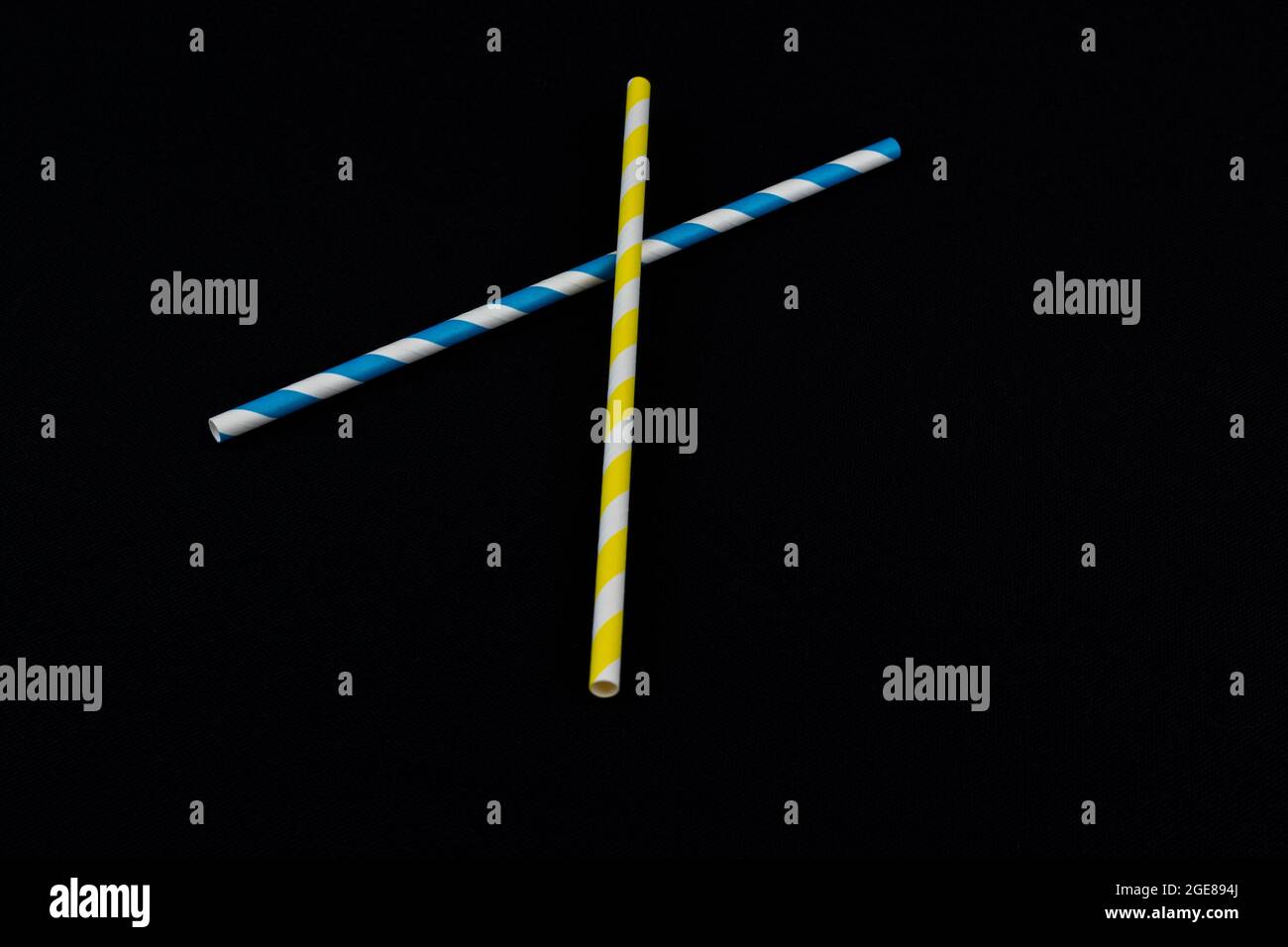 Multicolored paper straws isolated on a black background Stock Photo