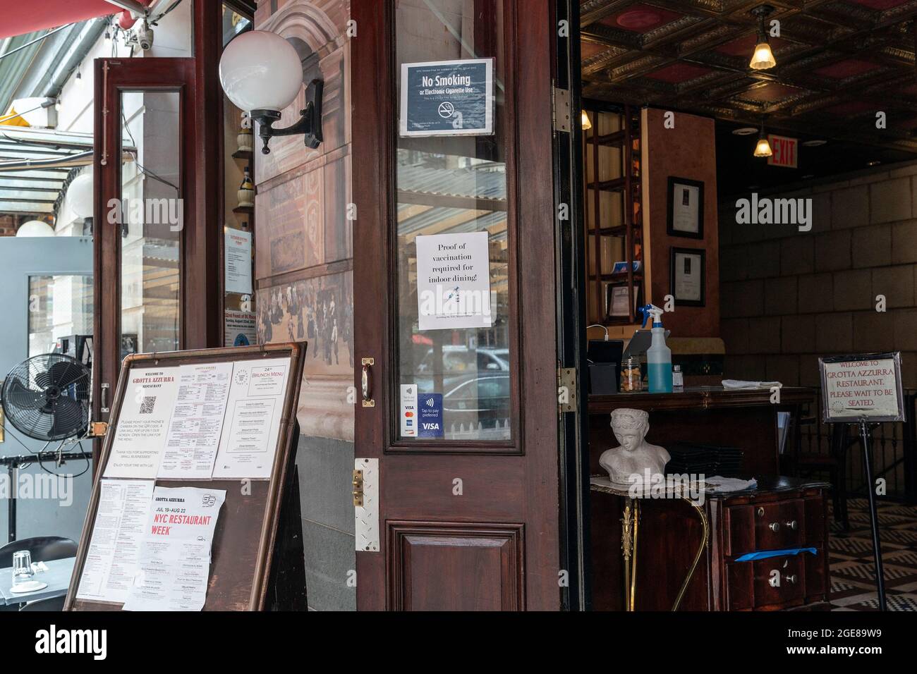 New York, United States. 17th Aug, 2021. View of Grotta Azzurra Restaurant on 1st day of vaccine mandate for indoor dining on order by mayor of the city. Poster seen on the doors advising clients of new rules for indoor dining and drinking. (Photo by Lev Radin/Sipa USA) Credit: Sipa USA/Alamy Live News Stock Photo