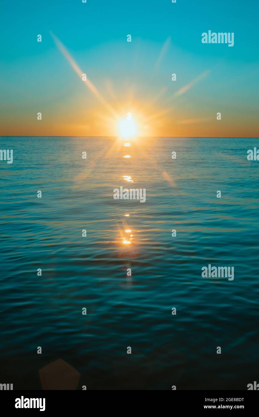 Sun rising over the water at Mollymook Beach Stock Photo - Alamy