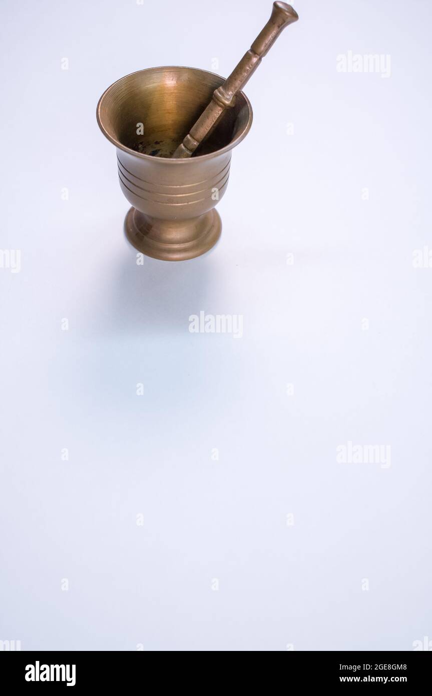 Vintage bronze mortar and pestle isolated on a white background with