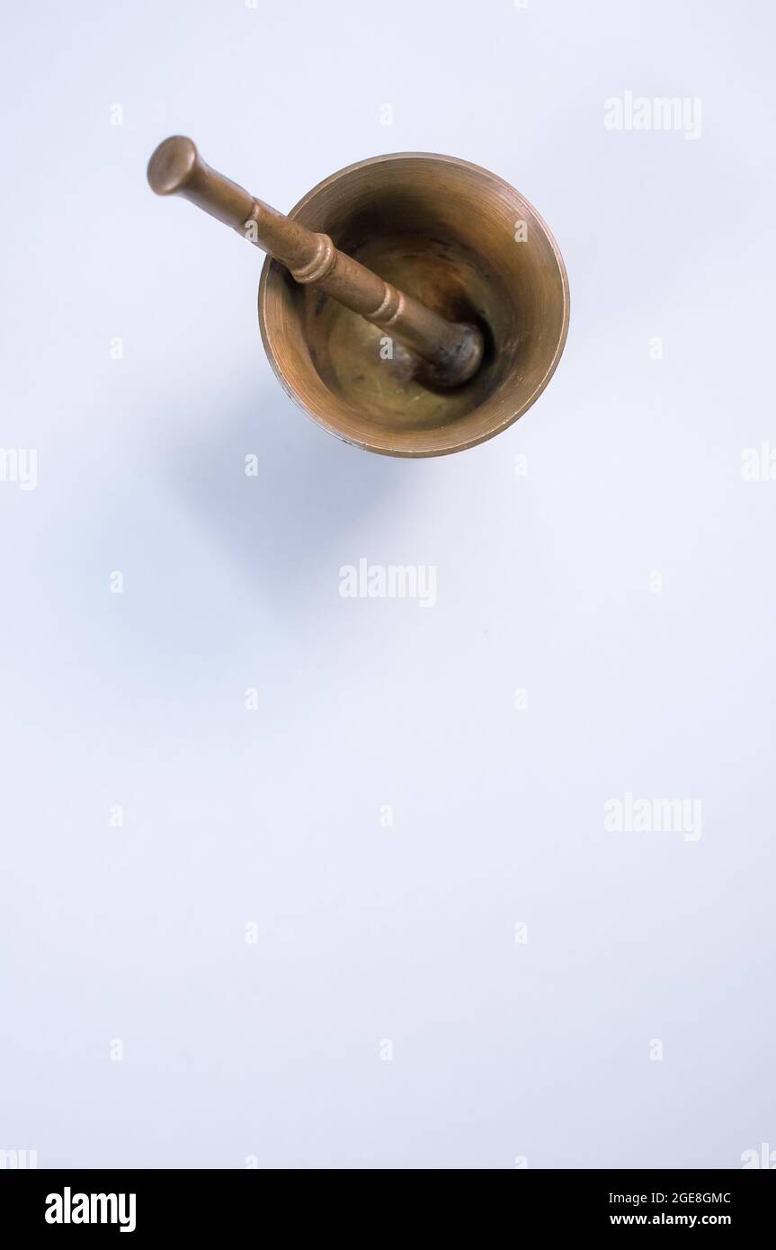 Vintage bronze mortar and pestle isolated on a white background with