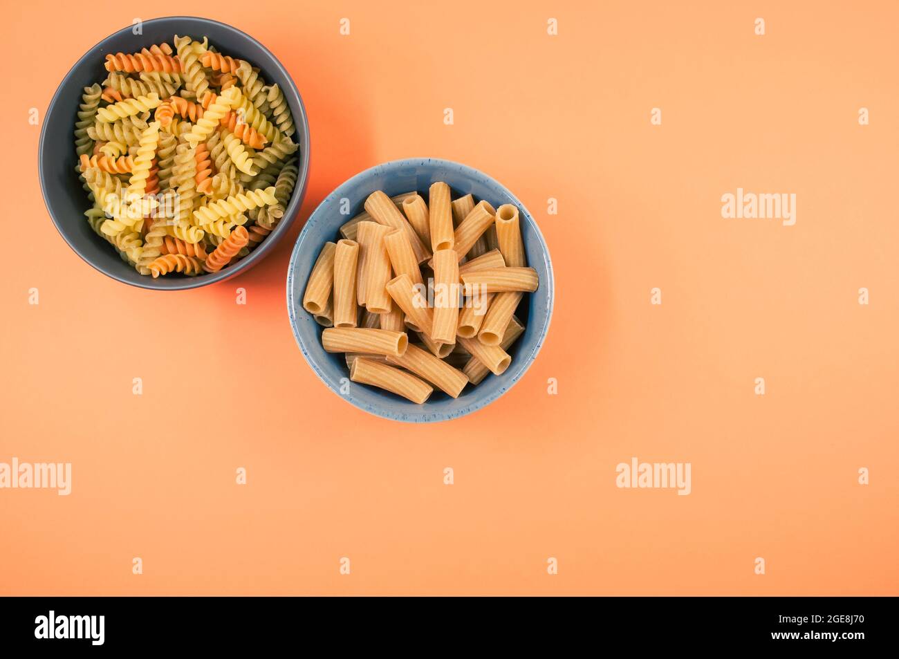 Top view of tricolor rotini and rigatoni pasta on a bowl isolated on