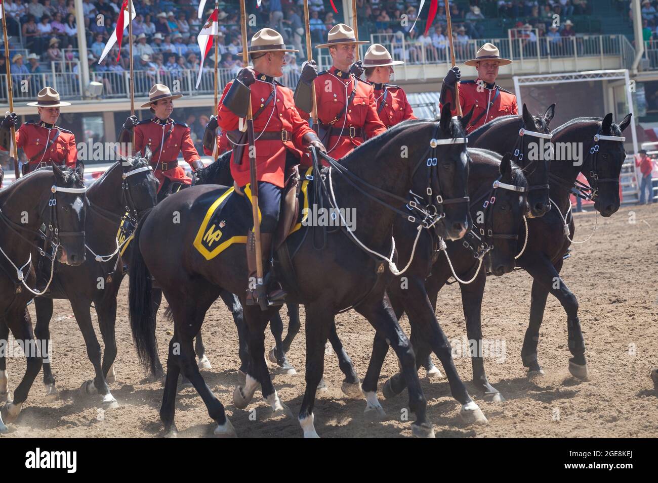 Jockeys in red uniform line up with their horses at the centenary event