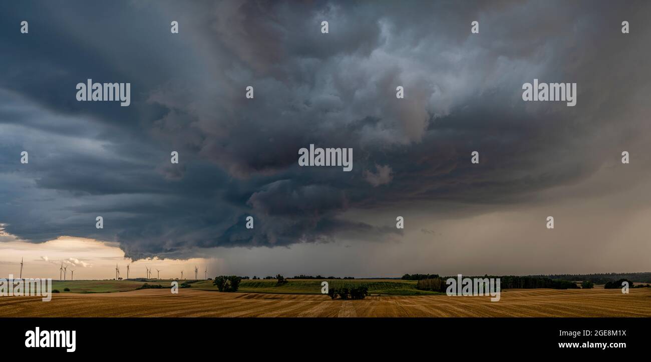 ThunderStorm over fields, a huge storm cloud that causes heavy rainfall Stock Photo