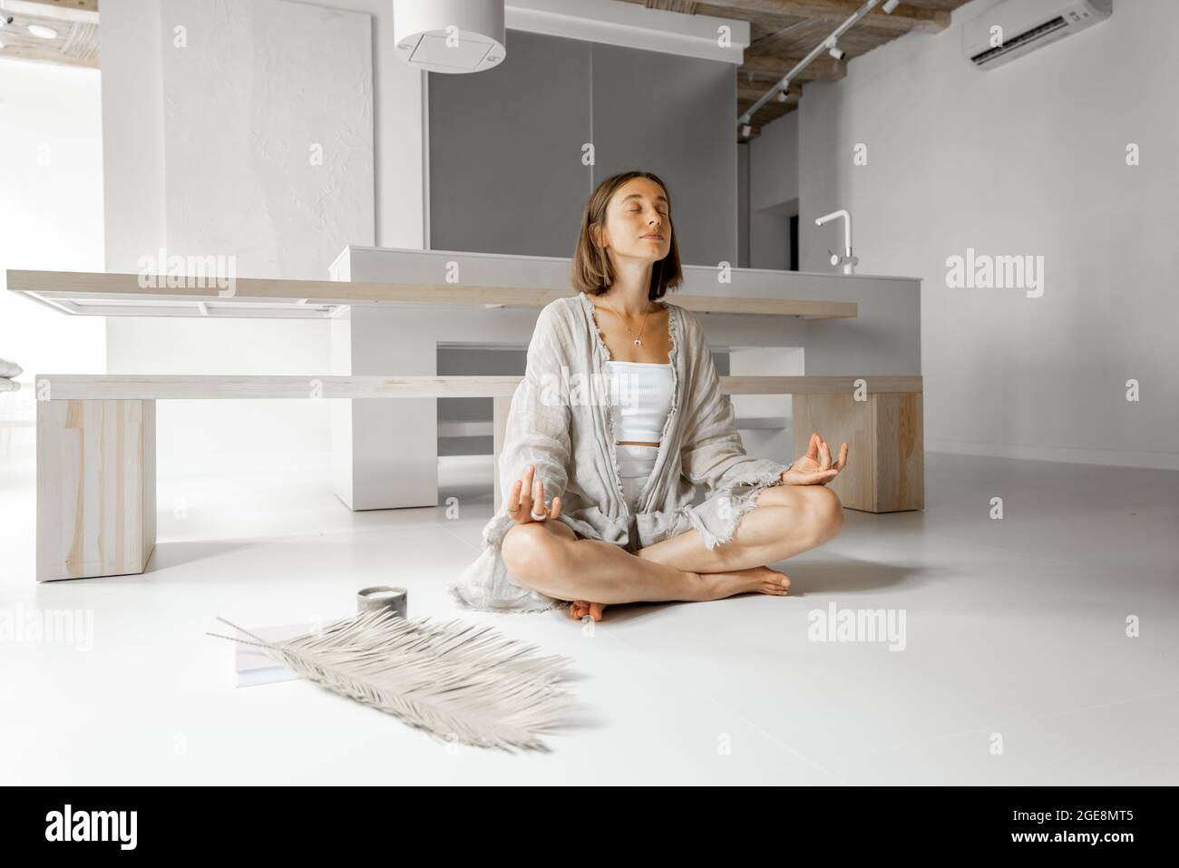 Woman meditating at home Stock Photo