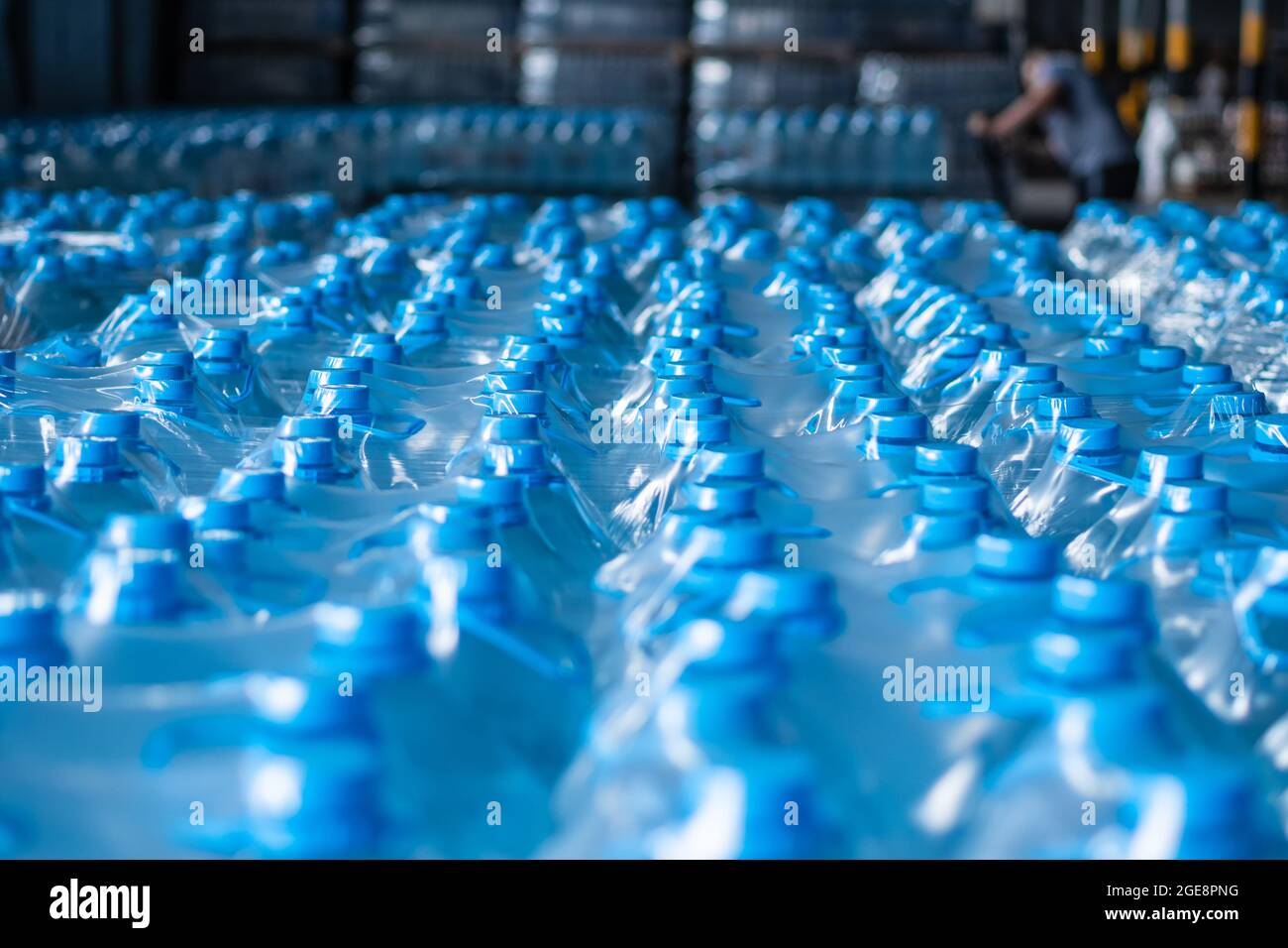 Packaged plastic water bottles in the finished product warehouse. Waiting their turn for shipment. Background image. Food production Stock Photo