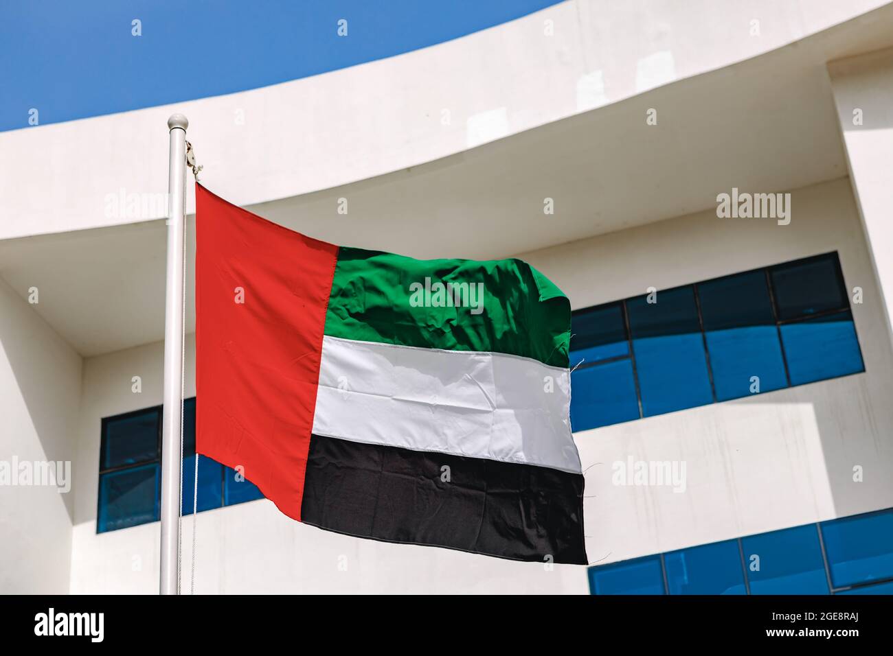 A United Arab Emirates flag flying in the wind Stock Photo