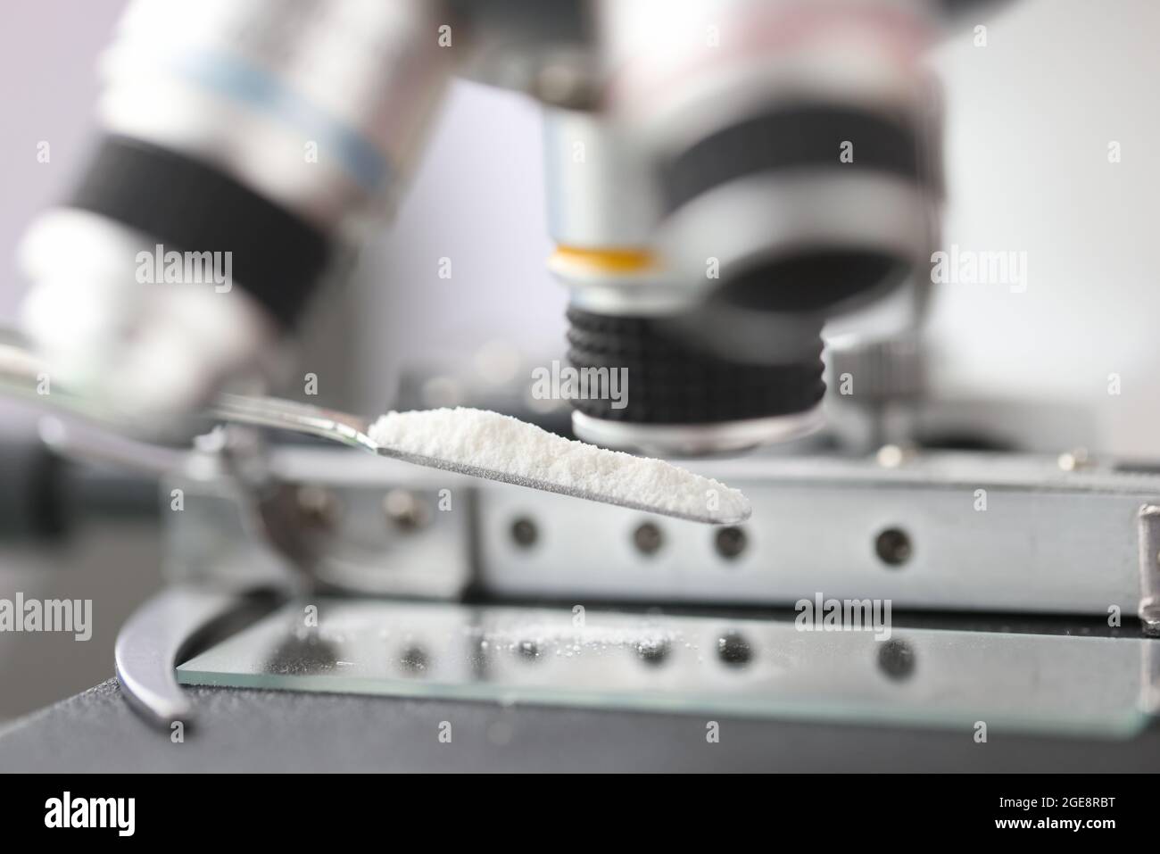 Study of white powder in a laboratory under microscope closeup Stock