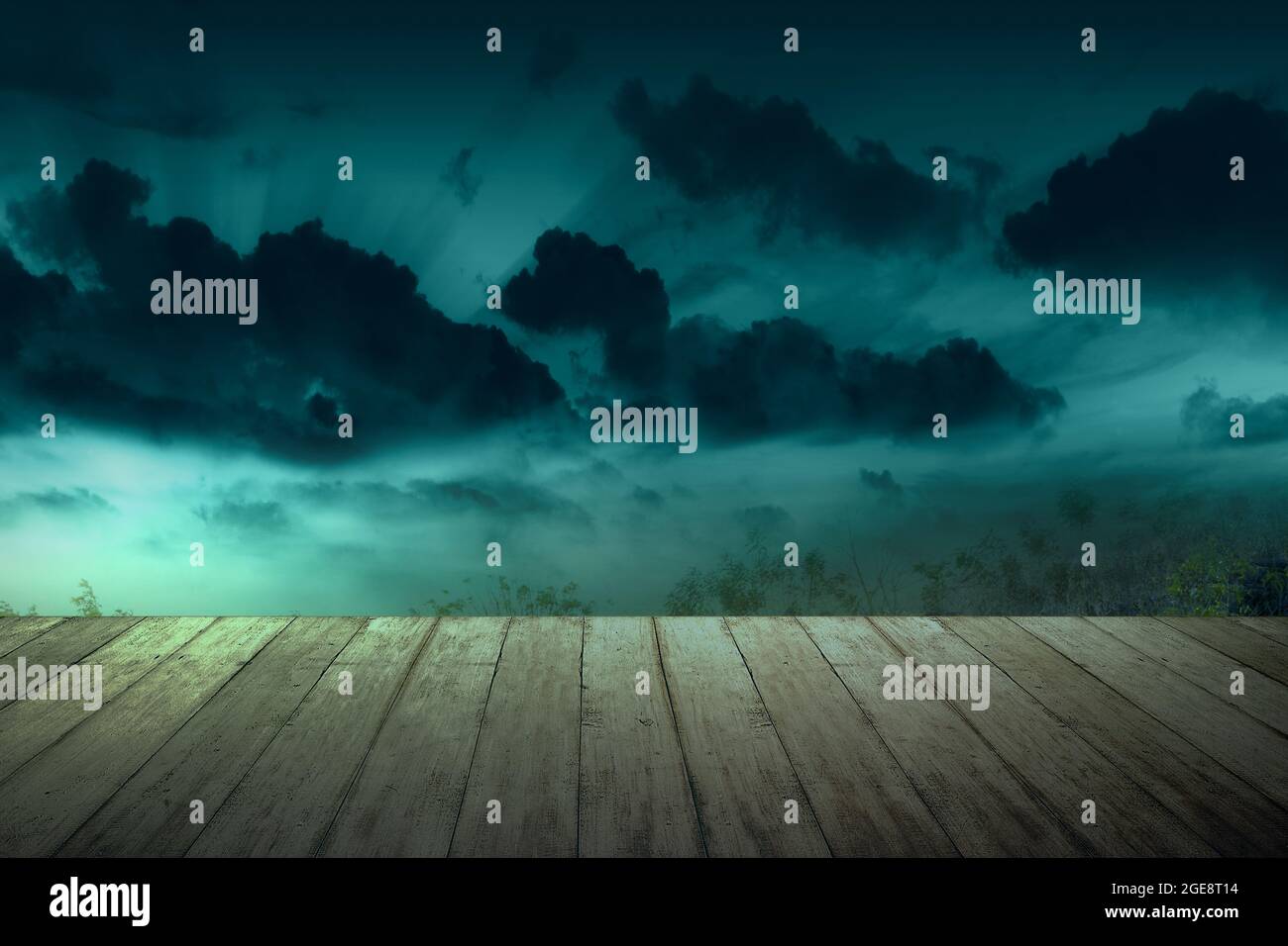 Wooden table with a full moon with dark cloudscapes on the night ...