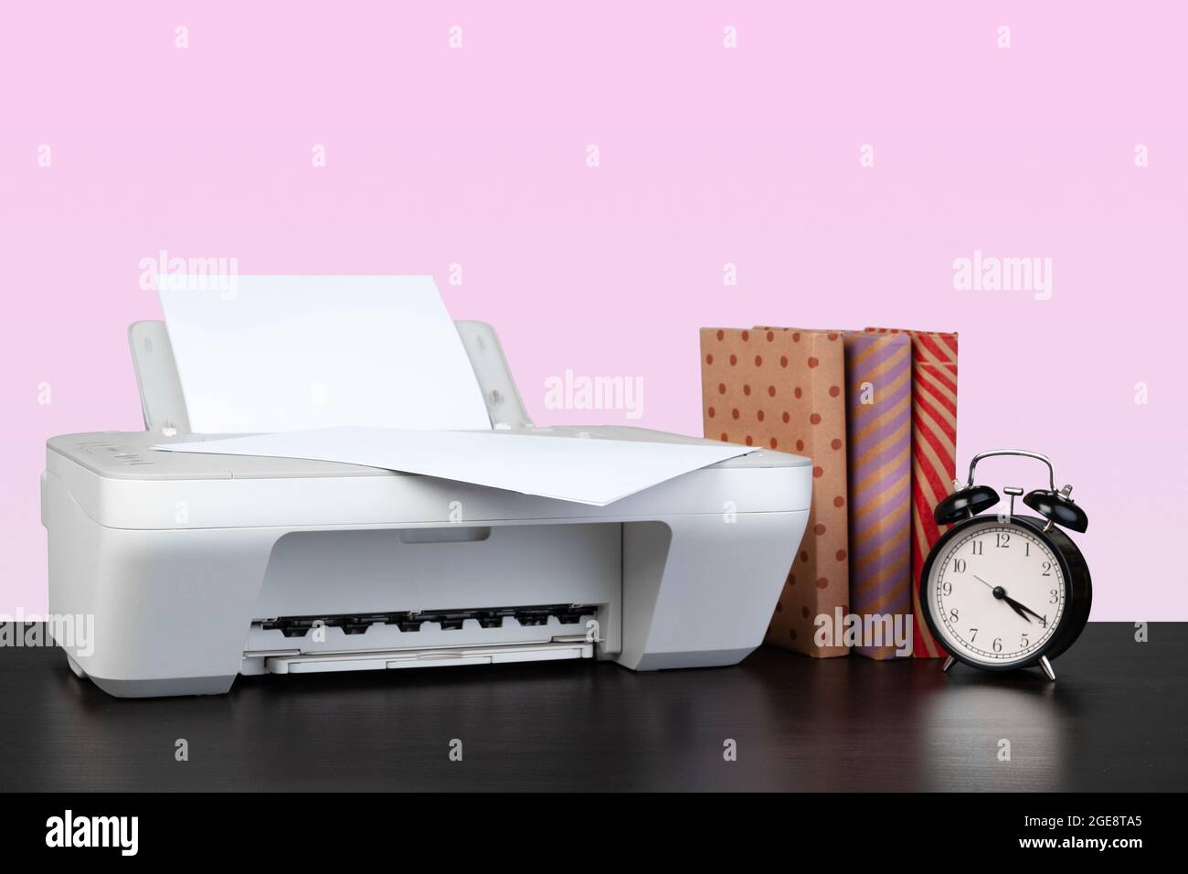 Compact home laser printer against pink background Stock Photo